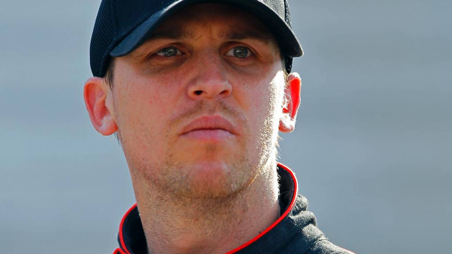 FILE - In this April 18, 2015, file photo, Driver Denny Hamlin looks at the time tower during practice for the NASCAR Sprint Cup Series auto race at Bristol Motor Speedway in Bristol, Tenn. Denny Hamlin will be back behind the wheel of his car this weekend at Richmond International Raceway, where he'll try to shine at his hometown track. His week begins early with his Short Track Showdown exhibition race, and he said the neck spasms that forced him out of the car last weekend have been addressed. (AP Photo/Wade Payne, File)