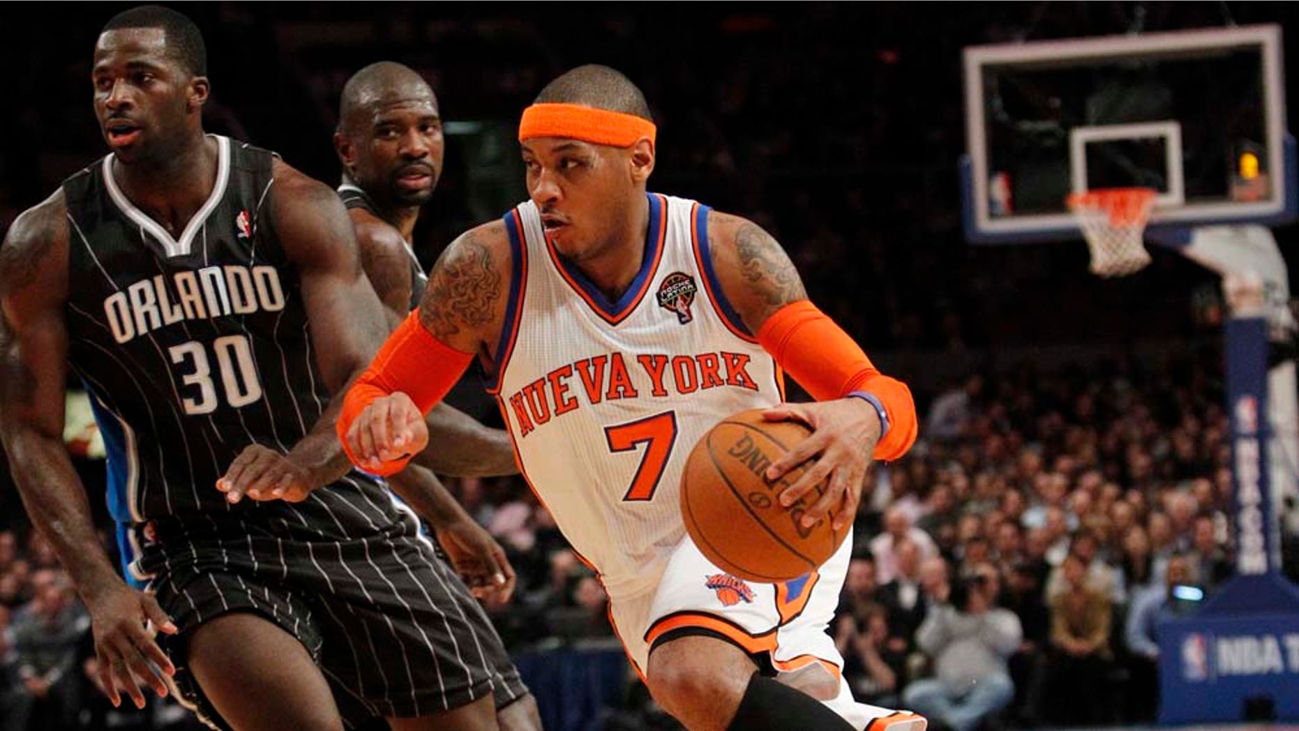 New York Knicks' Carmelo Anthony drives past Orlando Magic's Brandon Bass during the first half of an NBA basketball game on Wednesday, March 23, 2011, in New York. (AP Photo/Frank Franklin II)