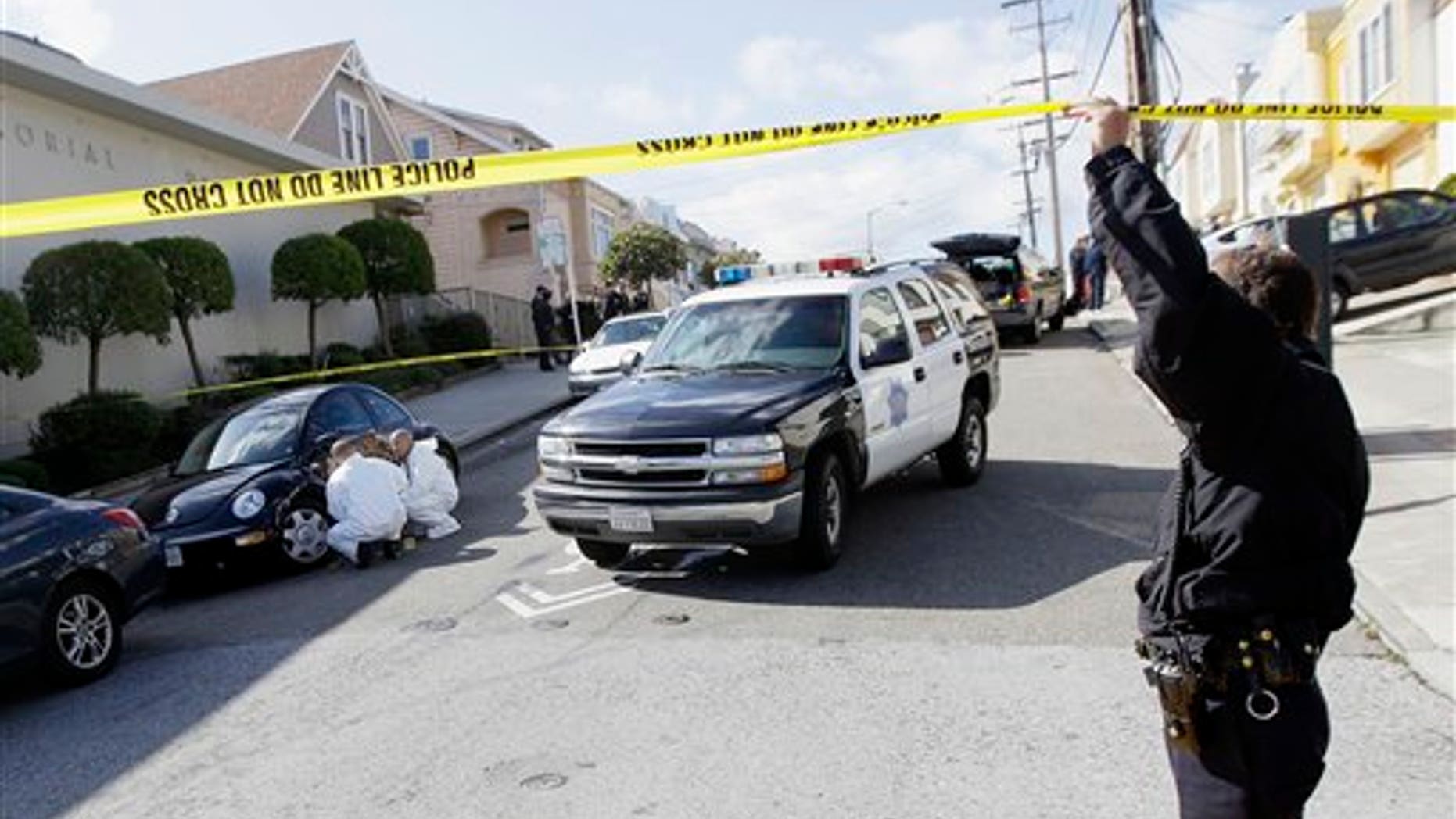 March 23: San Francisco Police officers inspect outside of a home on Howth Street in San Francisco.