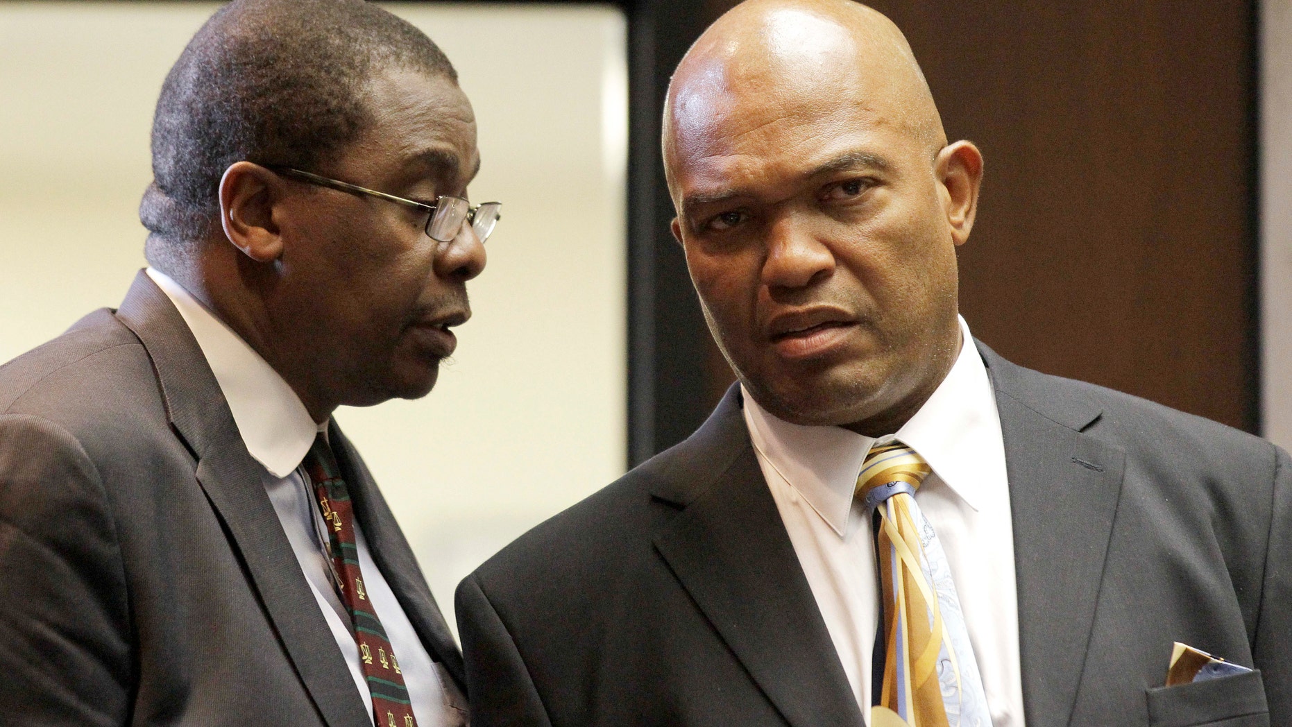 November 15: Lee Evans, right, of Irvington, N.J., who is defending himself, stands with his advising attorney Bukie O. Adetula, in a courtroom at Essex County Superior Court in Newark, N.J.