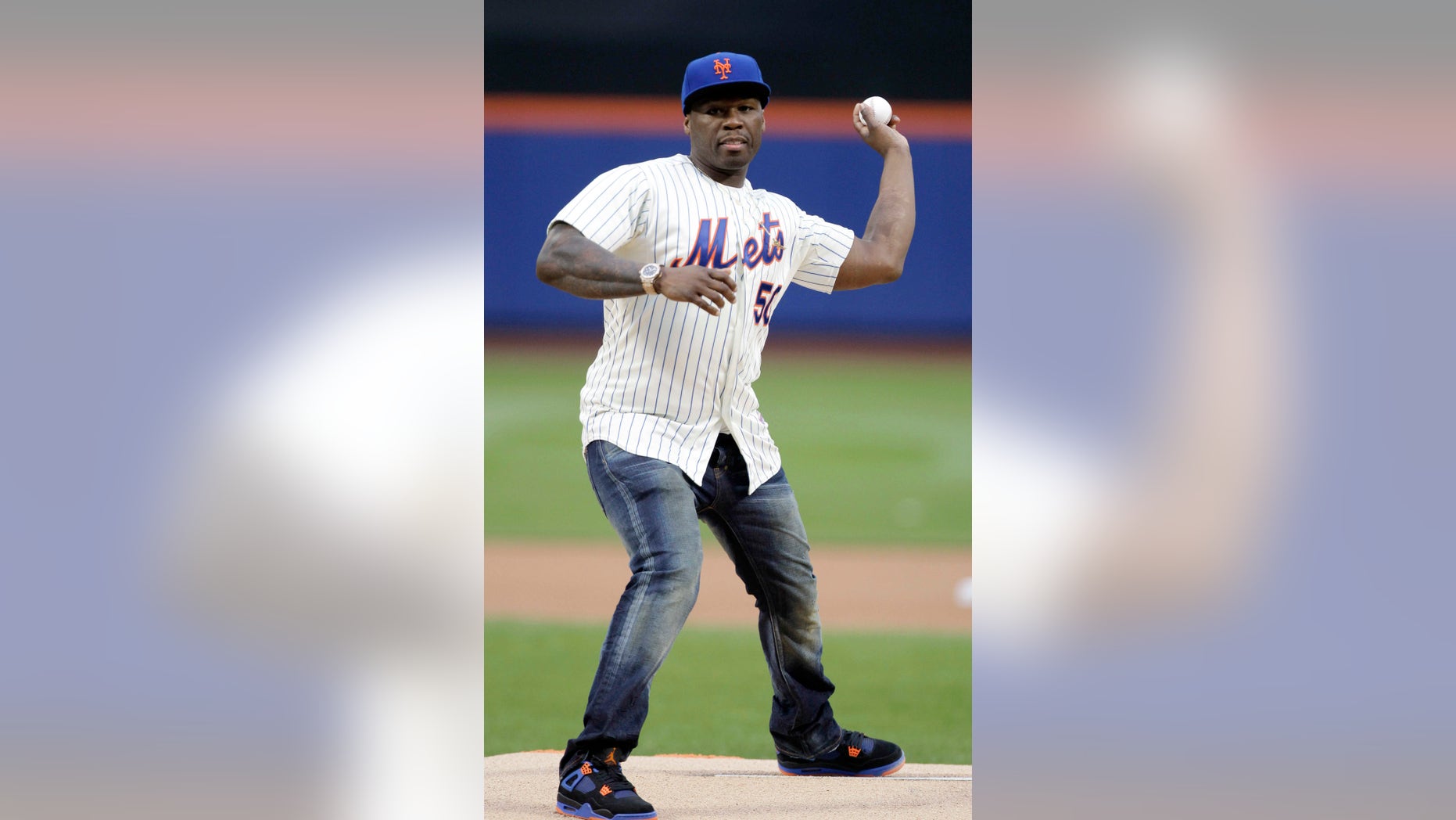 May 27, 2014. 50 Cent throws out the ceremonial first pitch before a baseball game between the New York Mets and the Pittsburgh Pirates in New York. (AP Photo/Frank Franklin II)