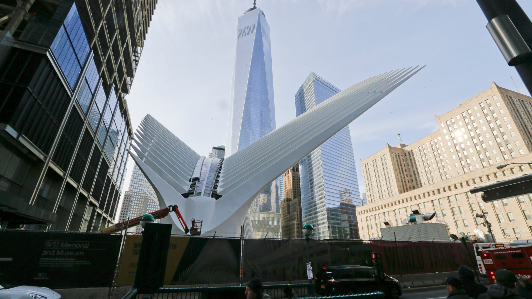 Pedestrians walk past the Oculus near World Trade Center Thursday, March 3, 2016, in New York. New Yorkers and tourists get their first look inside the cathedral-like hall that sits atop the new $4 billion train station at the World Trade Center. (AP Photo/Frank Franklin II)