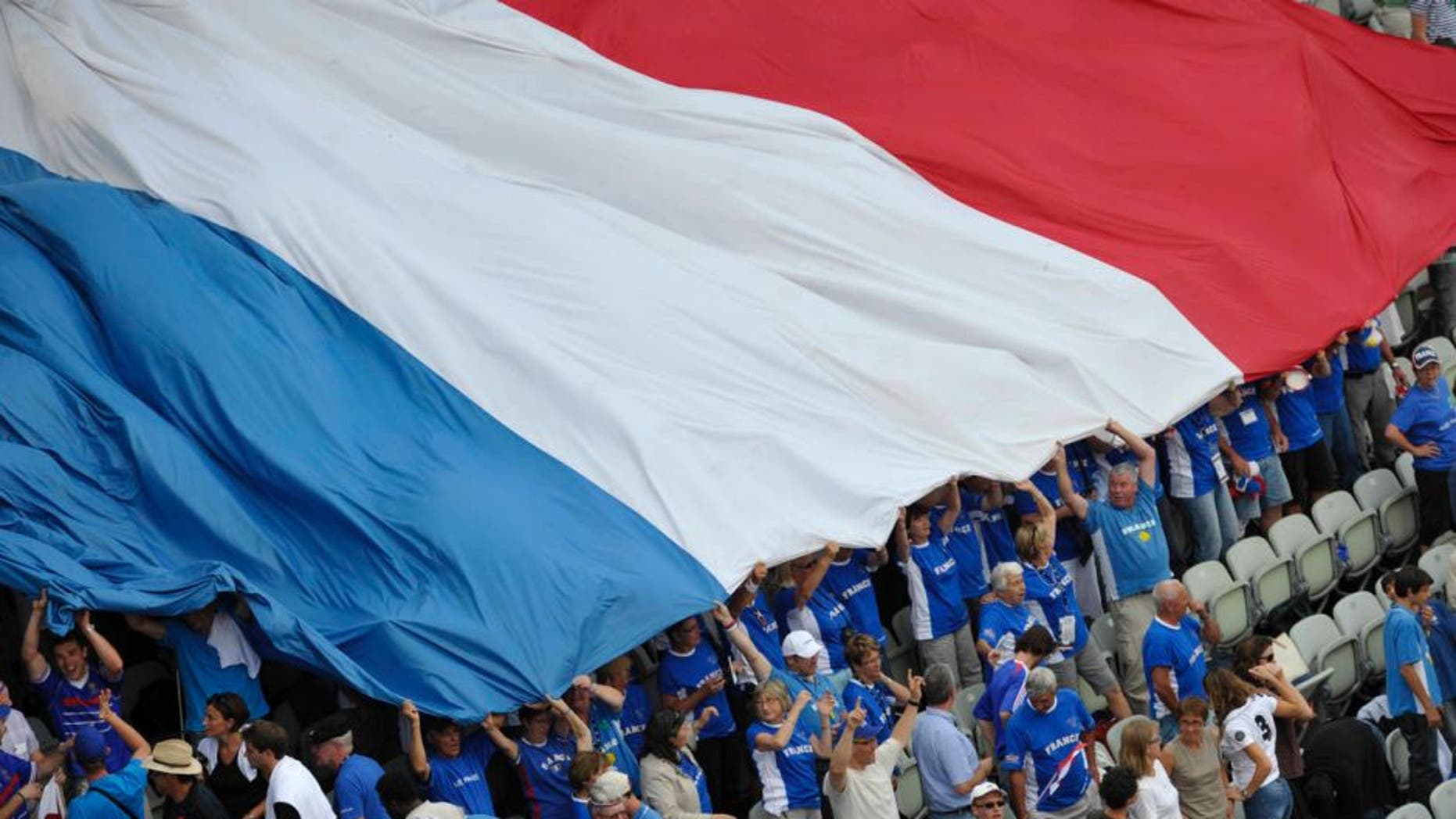 Fans of France's Davis Cup team celebrate on the stands with a French national flag as France's Gael Monfils has won the second set of his match against Germany's Philipp Kohlschreiber during the tennis Davis Cup quarter-final Germany vs France in Stuttgart, southern Germany, on July 8, 2011. The quarter-finals will take place from July 8 to 10, 2011 AFP PHOTO / THOMAS KIENZLE (Photo credit should read THOMAS KIENZLE/AFP/Getty Images)