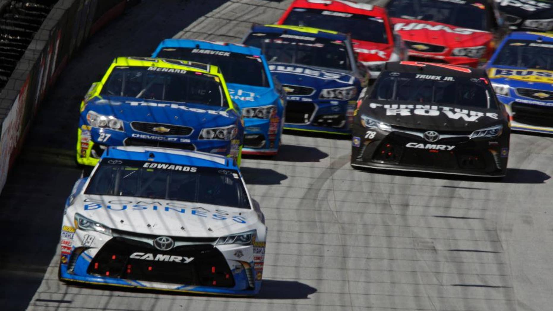 Sprint Cup Series driver Carl Edwards (19) leads the field during a NASCAR Sprint Cup Series auto race, Sunday, April 17, 2016, in Bristol, Tenn. (AP Photo/Wade Payne)