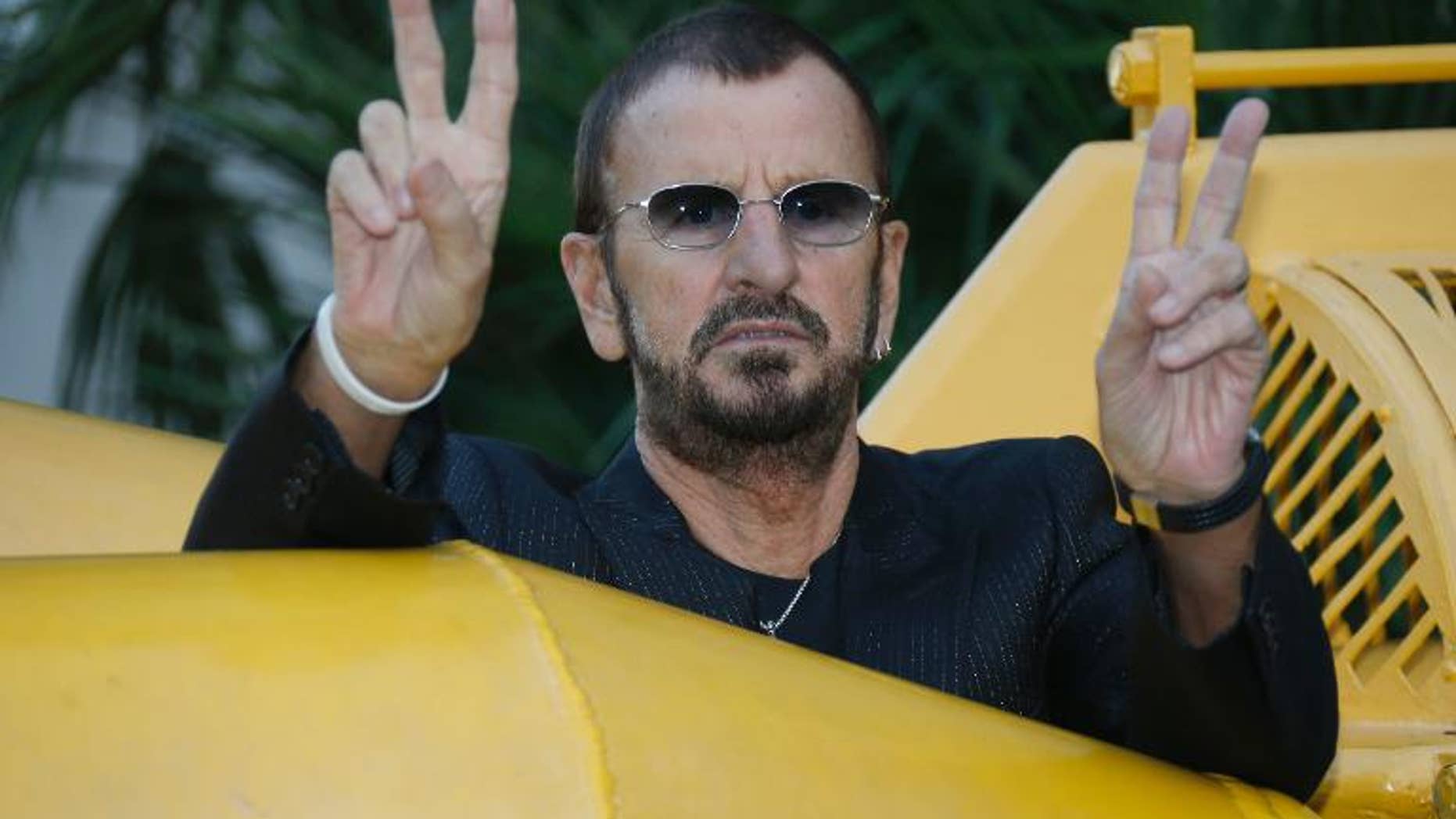 British artist and former drummer for the Beatles Ringo Starr poses next to a 1964 yellow submarine before the "Passion Ocean" exhibition inauguration on September 24, 2013 in Monaco.