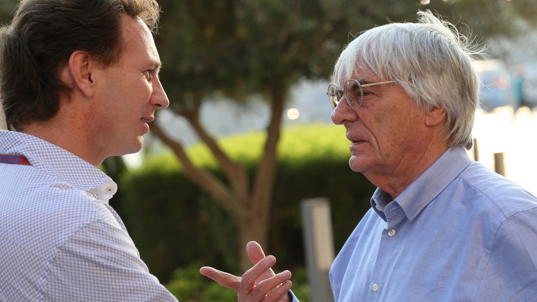 FILE - In this Thursday, Nov. 1, 2012 file photo, Red Bull team principal Christian Horner, left, talks with Bernie Ecclestone, president and CEO of Formula One Management, at the Yas Marina racetrack in Abu Dhabi, United Arab Emirates. With Ecclestone's Formula One future in doubt amid bribery allegations, one of the most influential team bosses on Wednesday, Jan. 15, 2014 said the series' prosperity relies on him remaining in charge. Christian Horner, team principal of reigning constructors' champion Red Bull, believes Ecclestone is "the only guy" who can ensure F1 maintains its global reach as the premier motorsport series. (AP Photo/Luca Bruno, File)