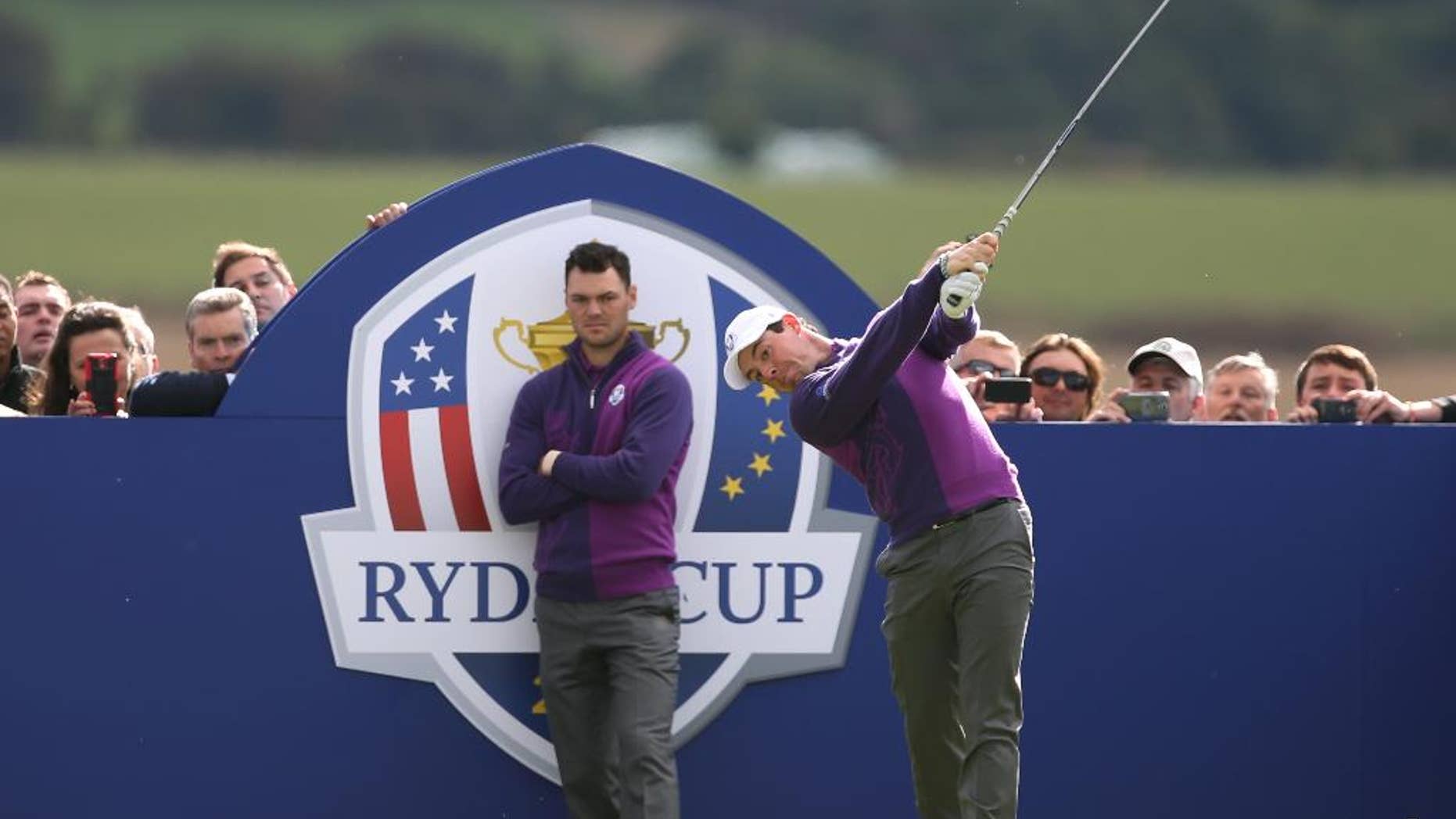 Europe’s Rory McIlroy plays off the 14th tee as Martin Kaymer looks on during a practice round ahead of the Ryder Cup golf tournament at Gleneagles, Scotland, Wednesday, Sept. 24, 2014. (AP Photo/Peter Morrison)