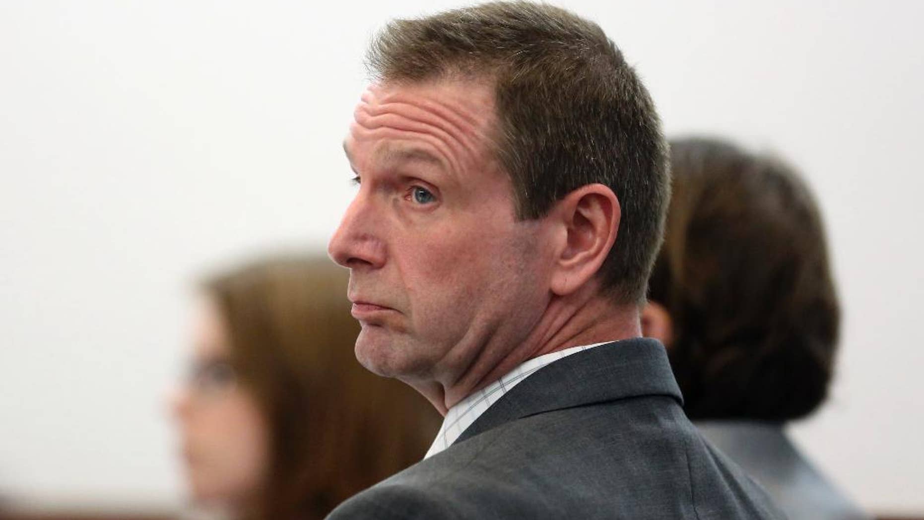 FILE - In this March 6, 2017 file photo, Curtis Lovelace looks over at prosecutors during his first-degree murder trial at the Sangamon County Courthouse in Springfield, Ill. Lovelace, a former Adams County assistant state's attorney, was acquitted in the 2006 death of his first wife, Cory Lovelace in his second murder trial Friday, March, 10, 2016 in Springfield, Ill. His first trial ended with a deadlocked jury. The jury of six men and six women deliberated for a little over two hours before determining Lovelace did not kill his wife. (Phil Carlson/The Quincy Herald-Whig via AP, Pool)