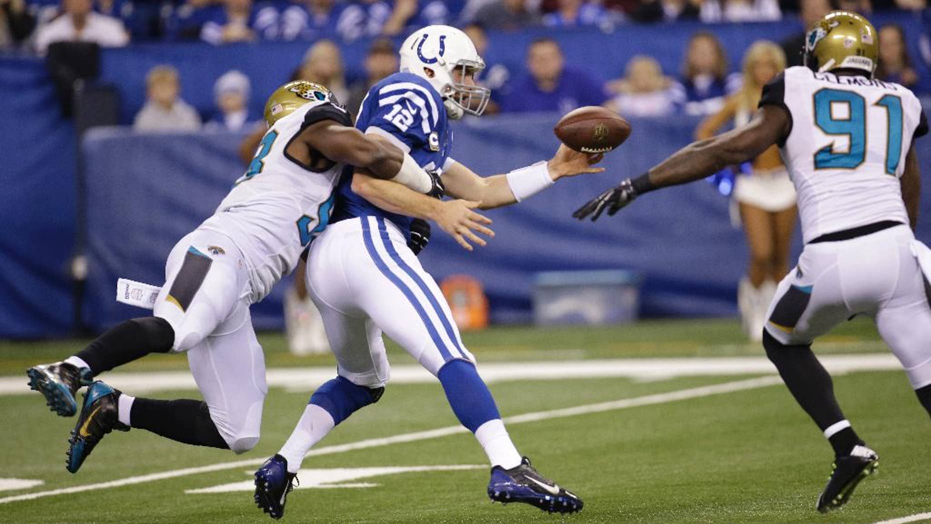 Indianapolis Colts quarterback Andrew Luck (12) fumbles after being hit by Jacksonville Jaguars defensive end Chris Smith (98) during the first half of an NFL football game Sunday, Nov. 23, 2014 in Indianapolis. (AP Photo/AJ Mast)