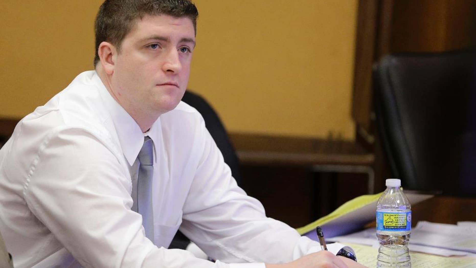 Cleveland police officer Michael Brelo listens to testimony during his trial Thursday, April 9, 2015, in Cleveland. Brelo is being tried on two counts of voluntary manslaughter in the November 2012 deaths of Timothy Russell, 43, and Malissa Williams, 30, after a high-speed chase. (AP Photo/Tony Dejak, Pool)