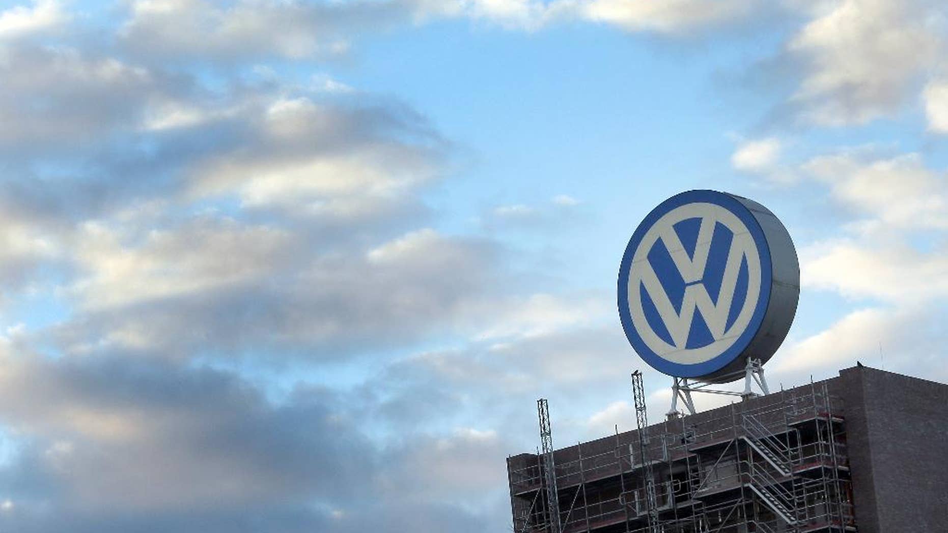 FILE - In this Sept. 26, 2015 file photo a giant logo of the German car manufacturer Volkswagen is pictured on top of a company's factory building in Wolfsburg, Germany. A member of Volkswagen's supervisory board is calling for a quick solution to a legal dispute between the automaker and two suppliers that has forced VW to suspend production of some models at German plants, affecting nearly 28,000 workers. (AP Photo/Michael Sohn, file)