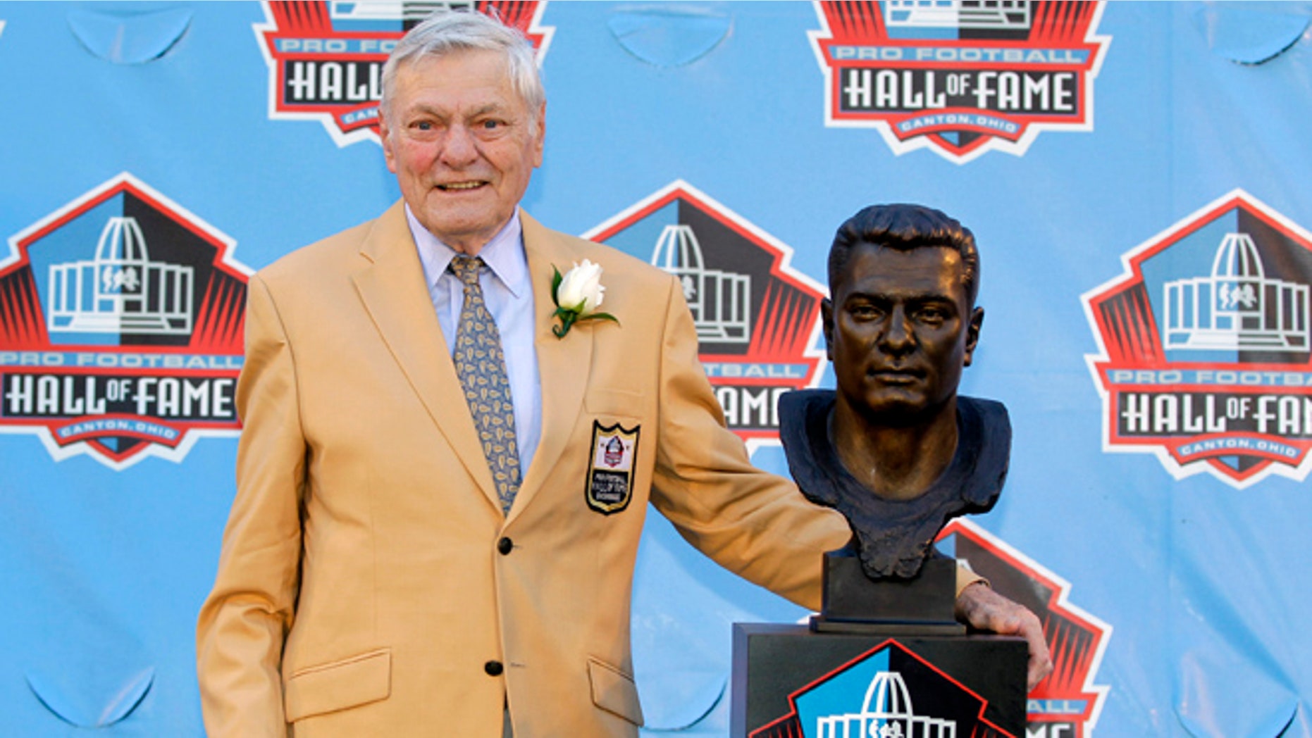 FILE- Int is Aug. 4, 2012, file photo, former NFL football player Jack Butler poses with a bust of himself during an induction ceremony at the Pro Football Hall of Fame in Canton, Ohio. Butler died Saturday morning, may 11, 2013, following a lengthy battle with a staph infection, his son John Butler said. He was 85. (AP Photo/Gene J. Puskar, File)