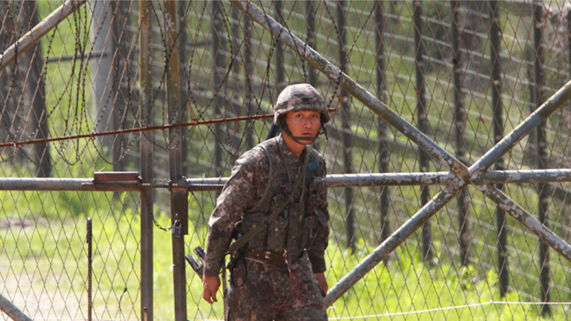 May 19, 2013: A South Korean army soldier passes by a barbed-wire fence in Paju, South Korea, near the border village of Panmunjom.