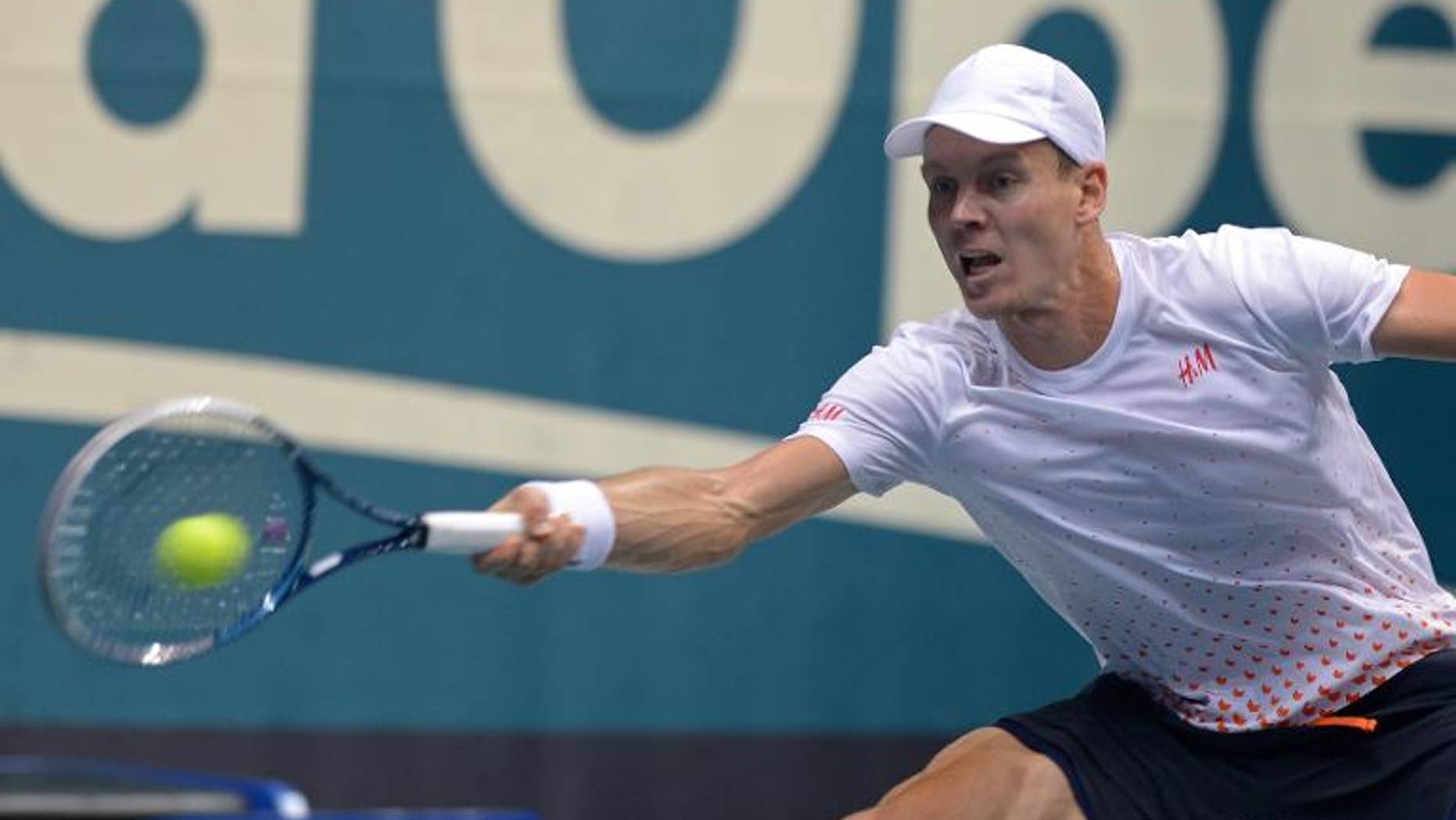 Tomas Berdych of the Czech Republic hits a return to Lu Yen-Hsun of Taiwan during the quarter final round of the ATP Thailand Open 2013 in Bangkok on September 27, 2013. Berdych beat Lu 7-6, 6-4.