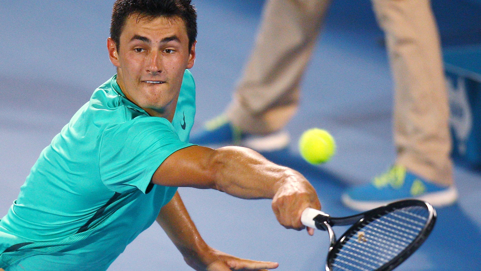 FILE - In this Saturday, Jan. 12, 2013 file photo Australia's Bernard Tomic plays a shot to Kevin Anderson of South Africa during the men's final at the Sydney International tennis tournament in Sydney, Australia. Bernard Tomic's hitting partner Thomas Drouet has called for the father of the Australian tennis player to be banned after he was allegedly assaulted on Saturday May 4, 2013. John Tomic has been charged with assault after allegedly headbutting Drouet ahead of this week's Madrid Open. (AP Photo/Rick Rycroft, File)