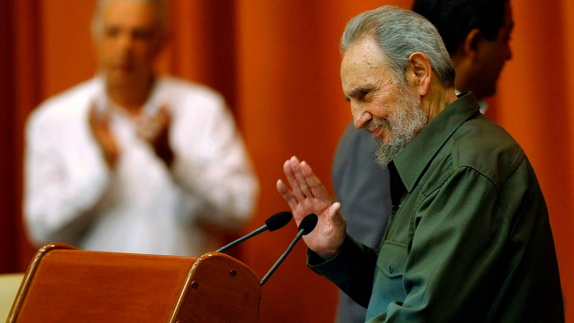 Fidel Castro waves during a special session of parliament, his first official government appearance in front of lawmakers in four years in Havana, Cuba, Saturday Aug. 7, 2010. (AP Photo/Frankly Reyes)
