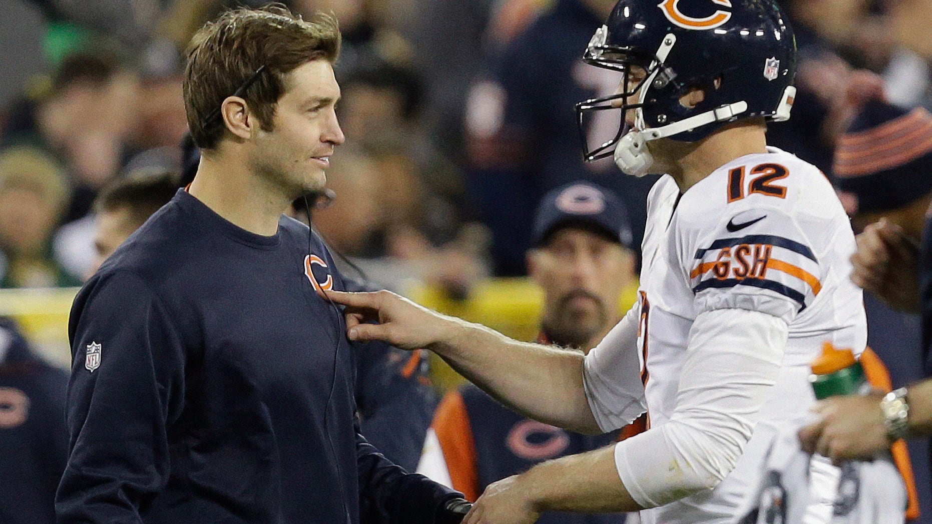 Chicago Bears quarterback Josh McCown (12) talks to Jay Cutler during the first half of an NFL football game against the Green Bay Packers Monday, Nov. 4, 2013, in Green Bay, Wis. (AP Photo/Mike Roemer)
