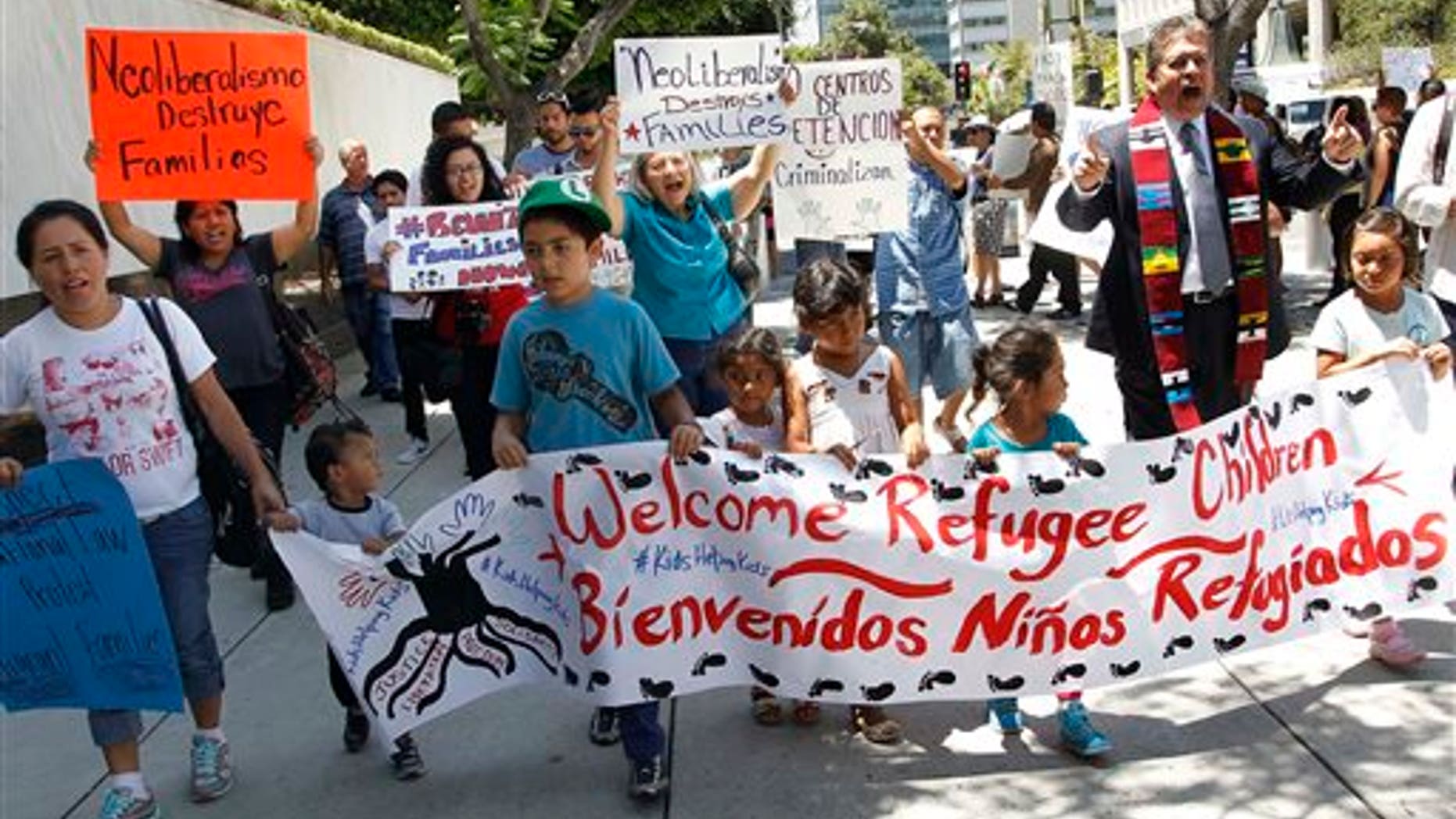 Immigrant families and children's advocates rally outside the Los Angeles Federal building Monday, July 7, 2014.