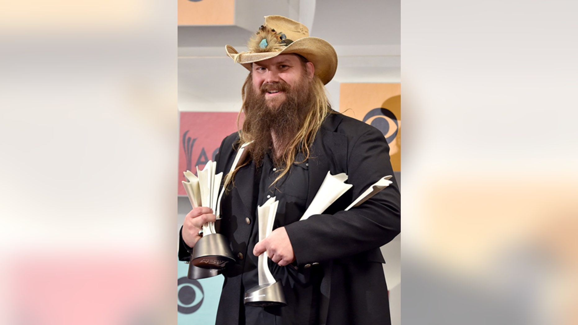 Chris Stapleton poses in the press room with the awards for album of the year for "Traveller", new male vocalist of the year, male vocalist of the year and song of the year for Nobody to Blame, at the 51st annual Academy of Country Music Awards at the MGM Grand Garden Arena on Sunday, April 3, 2016, in Las Vegas.