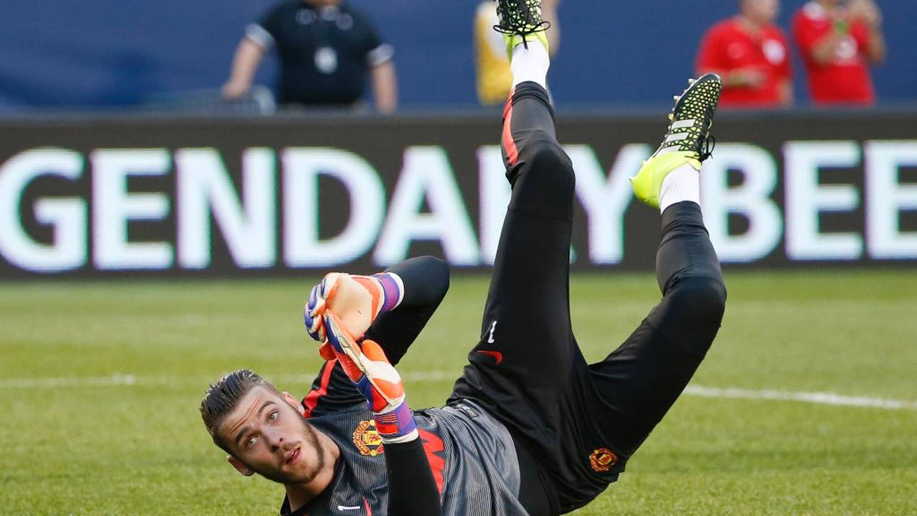 FILE - This is a Wednesday, July 29, 2015 file photo of Manchester United's goalkeeper David de Gea as he warms up before an International Champions Cup soccer match against Paris Saint-Germain in Chicago. Manchester United said Friday Sept. 11, 2015 that goalkeeper David De Gea has signed 4-year contract with the club. (AP Photo/Kamil Krzaczynski, File)