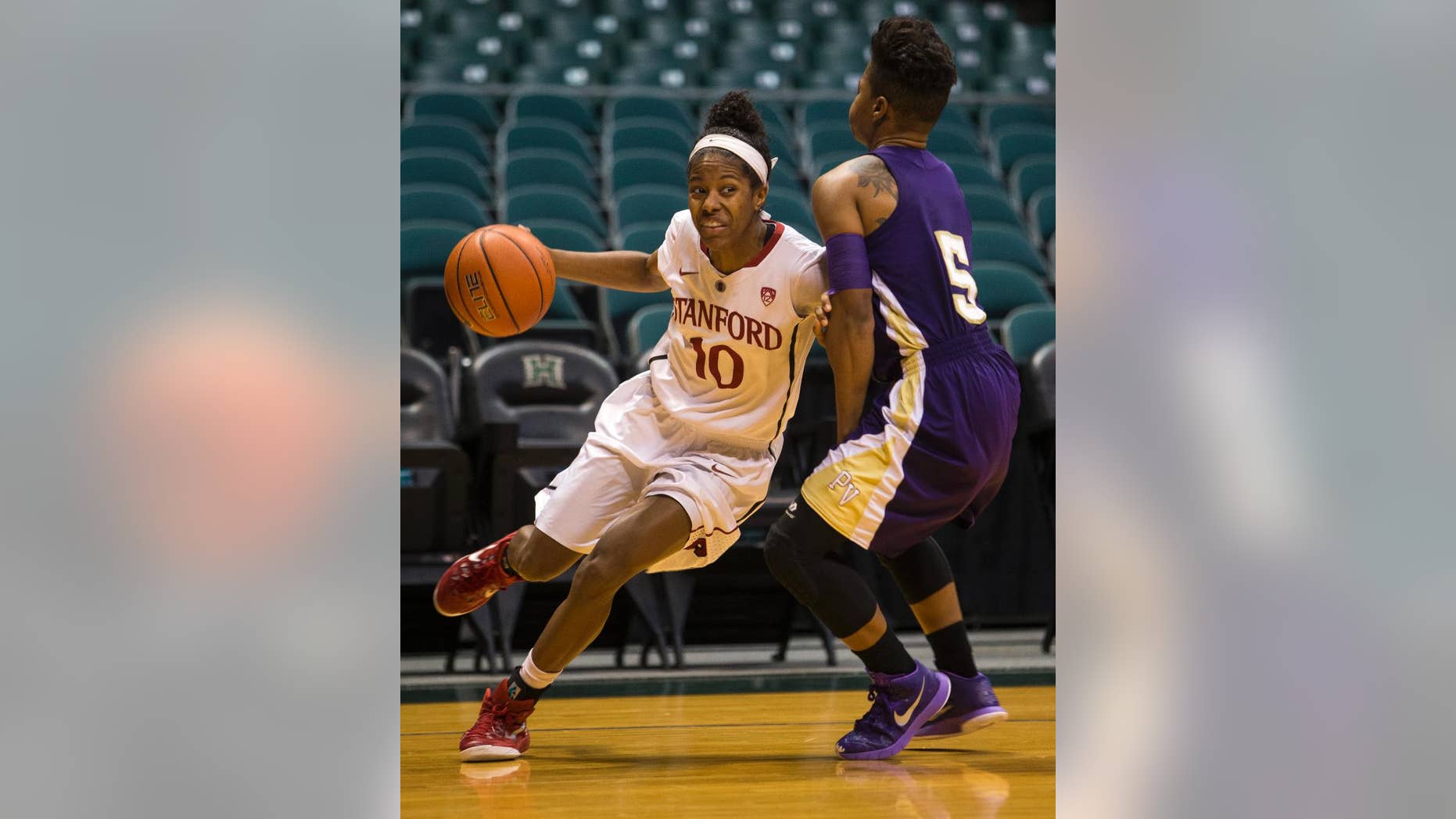 Stanford guard Briana Roberson (10) drives past Prairie View A&M Shaneece Stephens during the first half of an NCAA college basketball game, Sunday, Nov. 30, 2014 in Honolulu. (AP Photo/Marco Garcia)