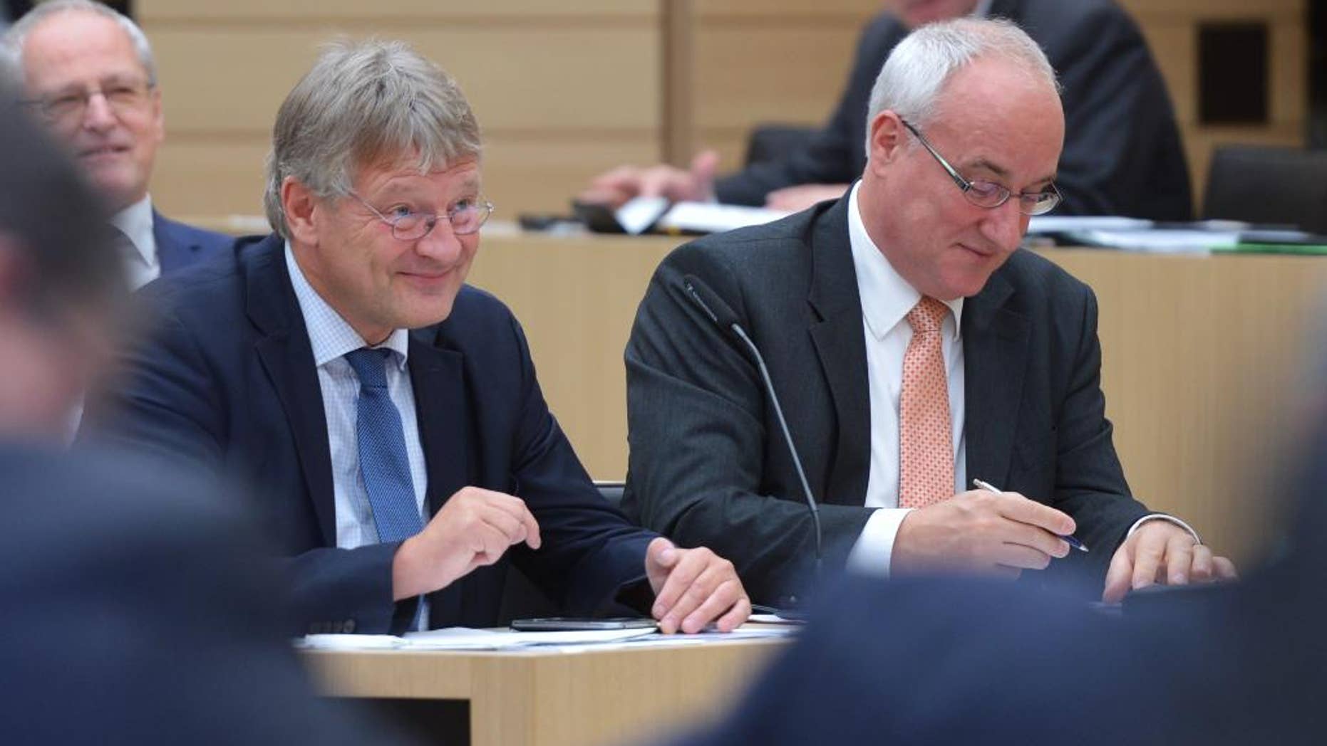 FILE - In this Sept. 28, 2016 file photo the AfD chairman Joerg Meuthen, left, and Heiner Merz attend a session of the state parliament in German state of Baden-Wuerttemberg. The German nationalist party has ended a dispute that split its parliamentary group in a state legislature and exposed divisions in its national leadership. (Silas Stein/dpa via AP)