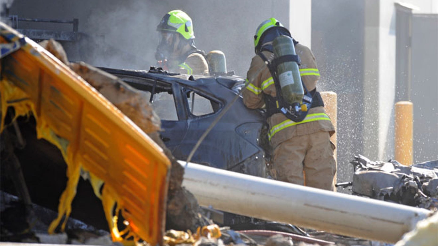 Emergency personnel work at a light plane crashed in Melbourne, Australia