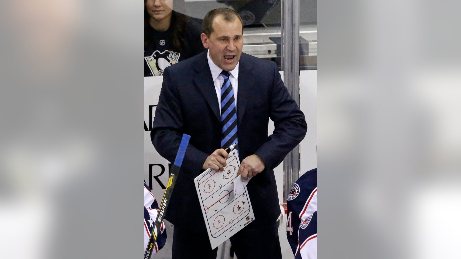 FILE - In this Dec. 9, 2013 file photo, Columbus Blue Jackets head coach Todd Richards gives instructions during a timeout in the third period of an NHL hockey game against the Pittsburgh Penguins in Pittsburgh. All of the Columbus Blue Jackets, including four members of the Russian Olympic team, and Richards, an assistant on the U.S. team, are back with the team and preparing for the NHL season's restart after a three-week respite.(AP Photo/Gene J. Puskar, File)