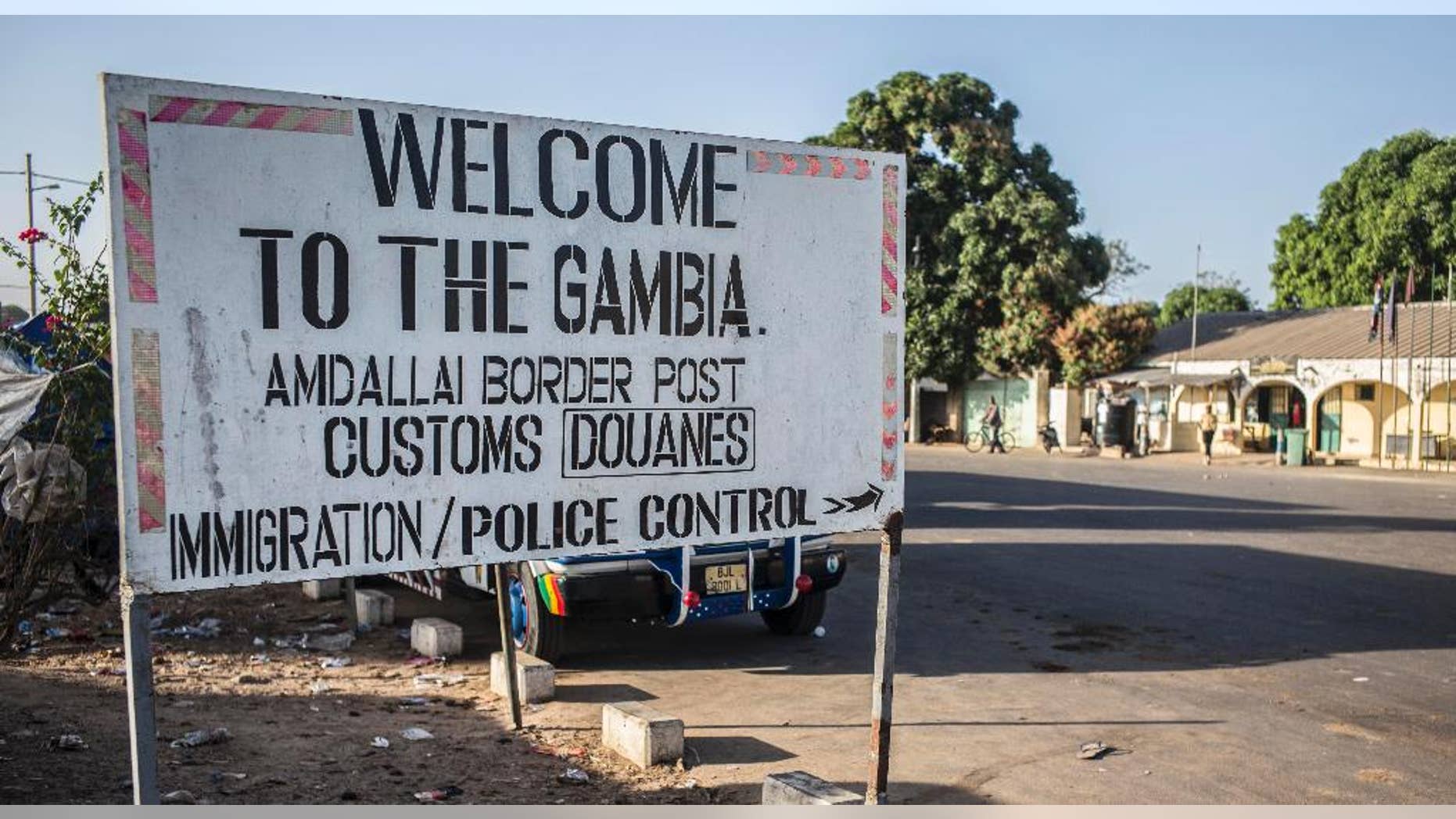 A sign at the border crossing between Gambia and Senegal near the town of Karang, Senegal, Thursday, Jan. 19, 2017. Gambia's president-elect said Thursday he will be sworn into office at the Gambian Embassy in neighboring Senegal, while there was no word from longtime leader Yahya Jammeh on the day that his mandate expired. (AP Photo/Sylvain Cherkaoui)