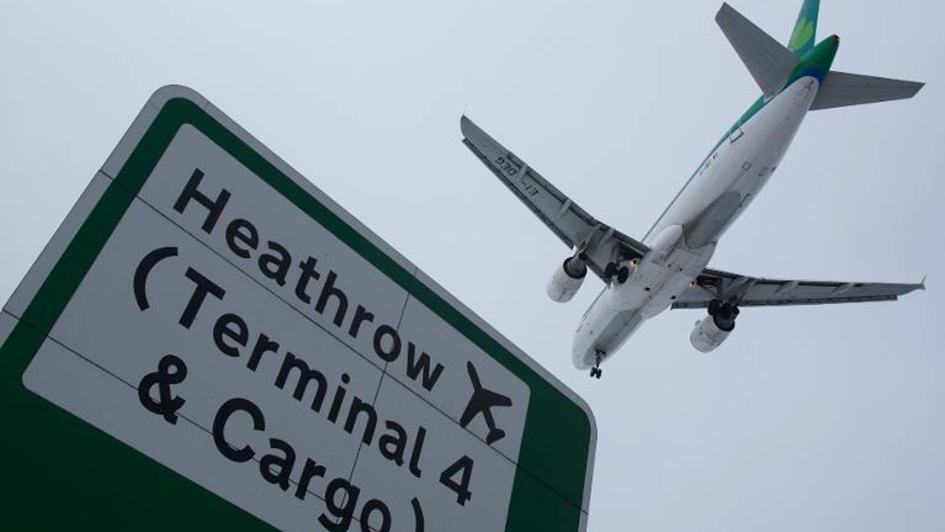 A plane flies in to land at Heathrow airport in west London on January 21, 2013