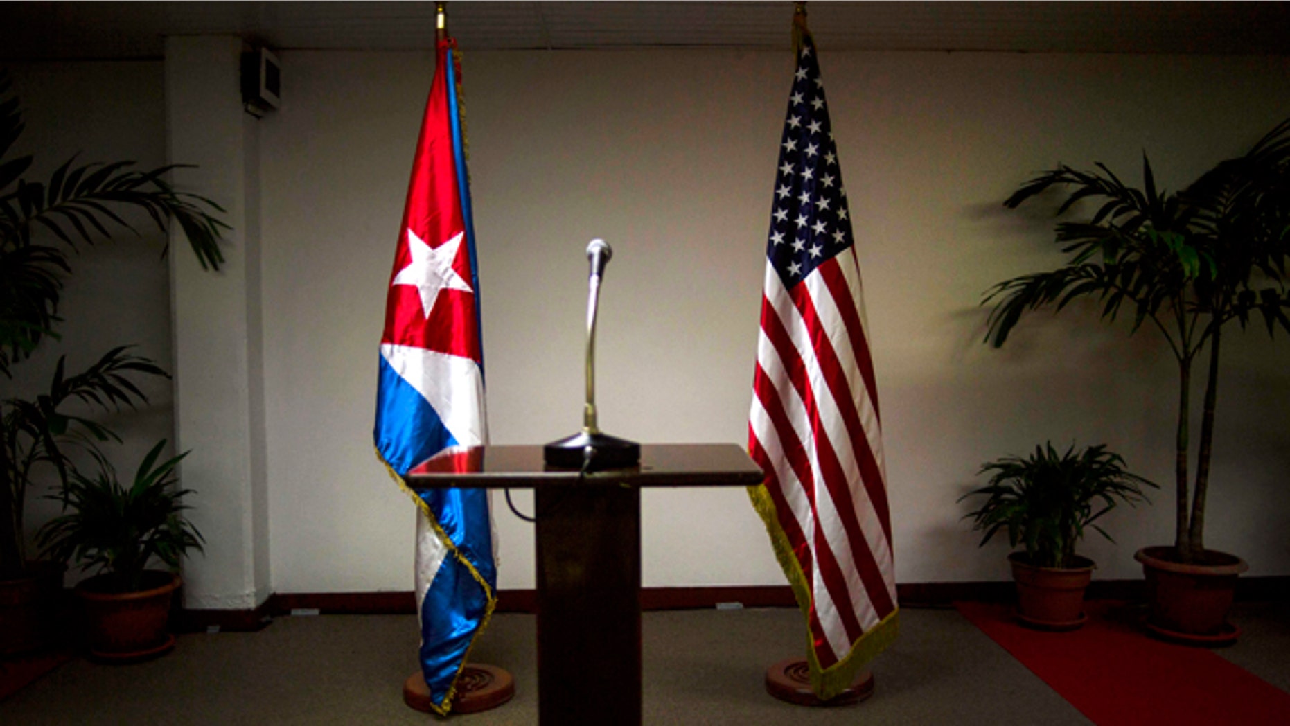 FILE - In this Jan. 22, 2015 file photo, Cuban and U.S. flags stand before the start of a press conference on the sidelines of talks between the two nations in Havana, Cuba. Members of the U.S. Democratic congressional delegation to Cuba said on Tuesday, Feb. 17, 2015 the next round of negotiations on restoring full diplomatic ties with Cuba will take place in Washington next week. (AP Photo/Ramon Espinosa, File)