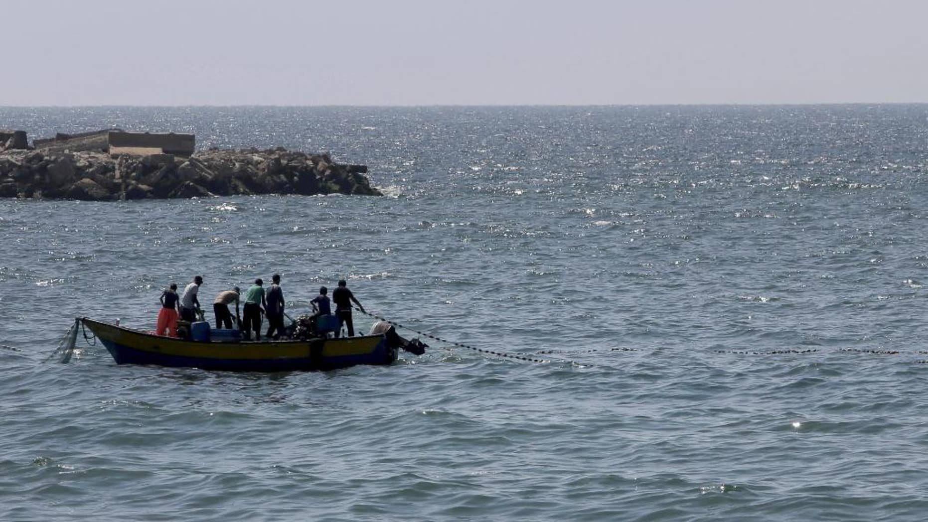 Aug. 7, 2014: Palestinian fishermen pull their fishnet at the Mediterranean Sea in Gaza City in the northern Gaza Strip. (AP)