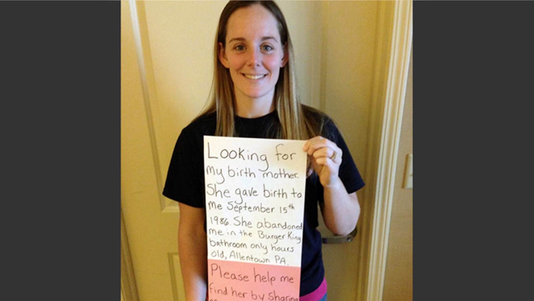 March 2, 2014: This photo provided by Katheryn Deprill that she posted on Facebook shows her holding a sign that says she is seeking her birth mother.
