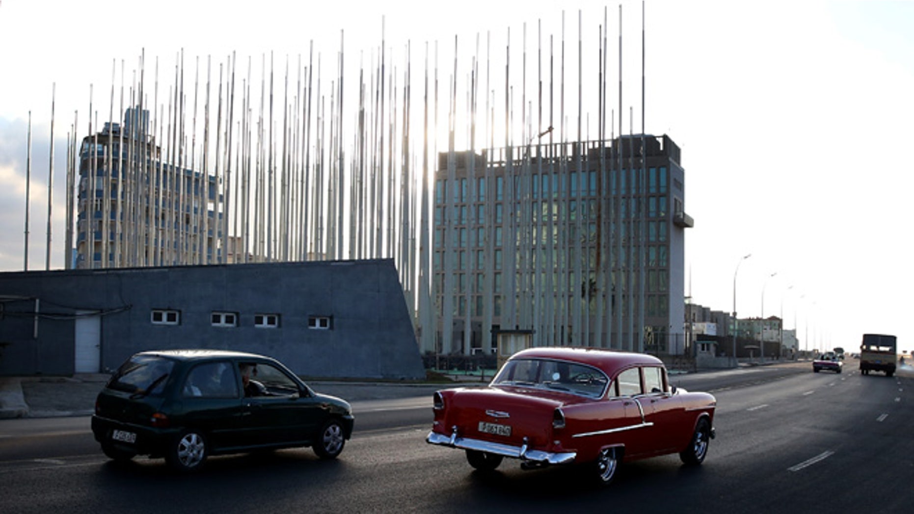 HAVANA, CUBA - FEBRUARY 25: Flag poles are seen in front of the United States Interests Section as Cuba and the U.S. governments prepare for the second round of discussions to restore diplomatic relations on February 25, 2015 in Havana, Cuba. Among the discussions scheduled for Friday will be converting the Interests Section back to a U.S. Embassy. (Photo by Joe Raedle/Getty Images)