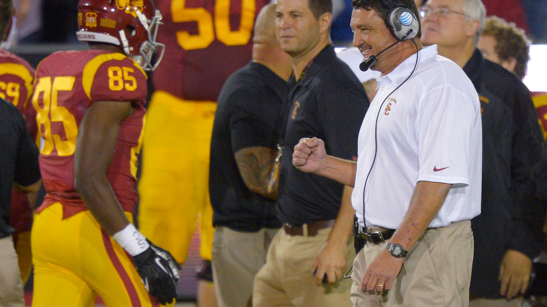 Southern California interim coach Ed Orgeron, right, celebrates after USC scored a touchdown during the first half of an NCAA college football game against Arizona, Thursday, Oct. 10, 2013, in Los Angeles. (AP Photo/Mark J. Terrill)