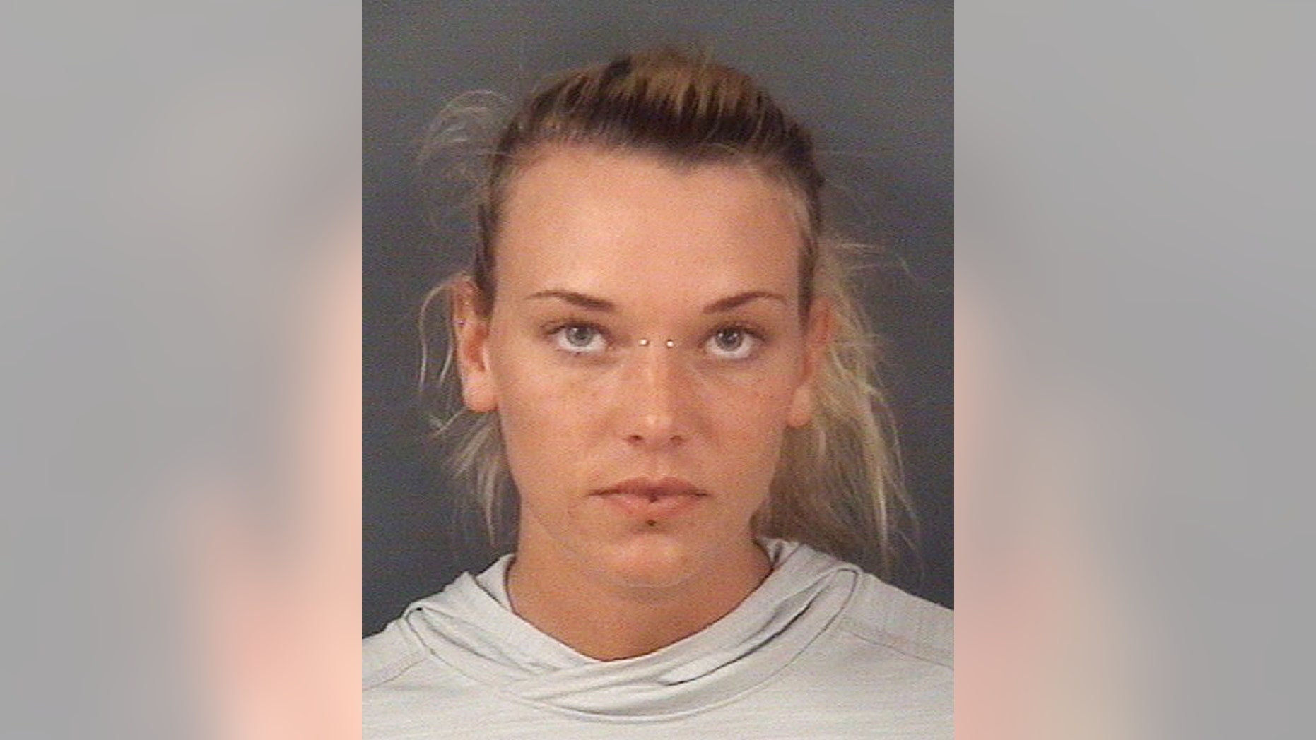 In this undated photo released by the Cumberland County Sheriff's Office, in Fayetteville, N.C., Marinna Rollins, poses for a photo. Rollins was arrested Tuesday, April 25, 2017, and charged with cruelty to animals. The veteran has been charged with tying her service dog to a tree and shooting it five times while a soldier filmed it. (Cumberland County Sheriff's Office via AP)