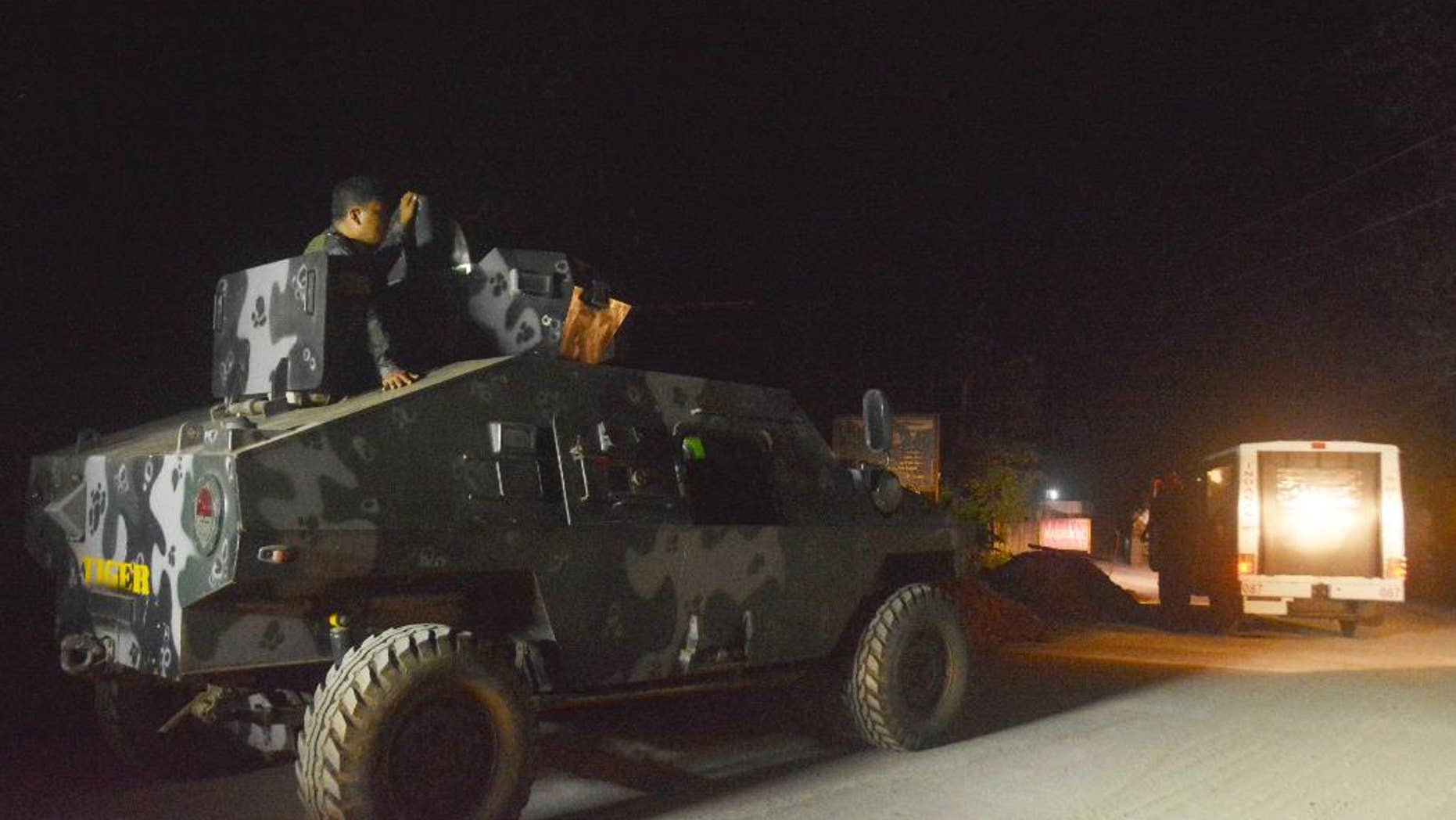 Philippine marines escort a police van believed to be carrying the body of German hostage Juergen Gustav Kantner, on Jolo island in southern Philippines Sunday, March 5, 2017. Philippine troops have found the remains of the German hostage who was beheaded by Abu Sayyaf militants in the country's south, vowing Sunday to rescue more than 30 other captives and crush the ransom-seeking extremists. (AP Photo/Nickee Butlangan)