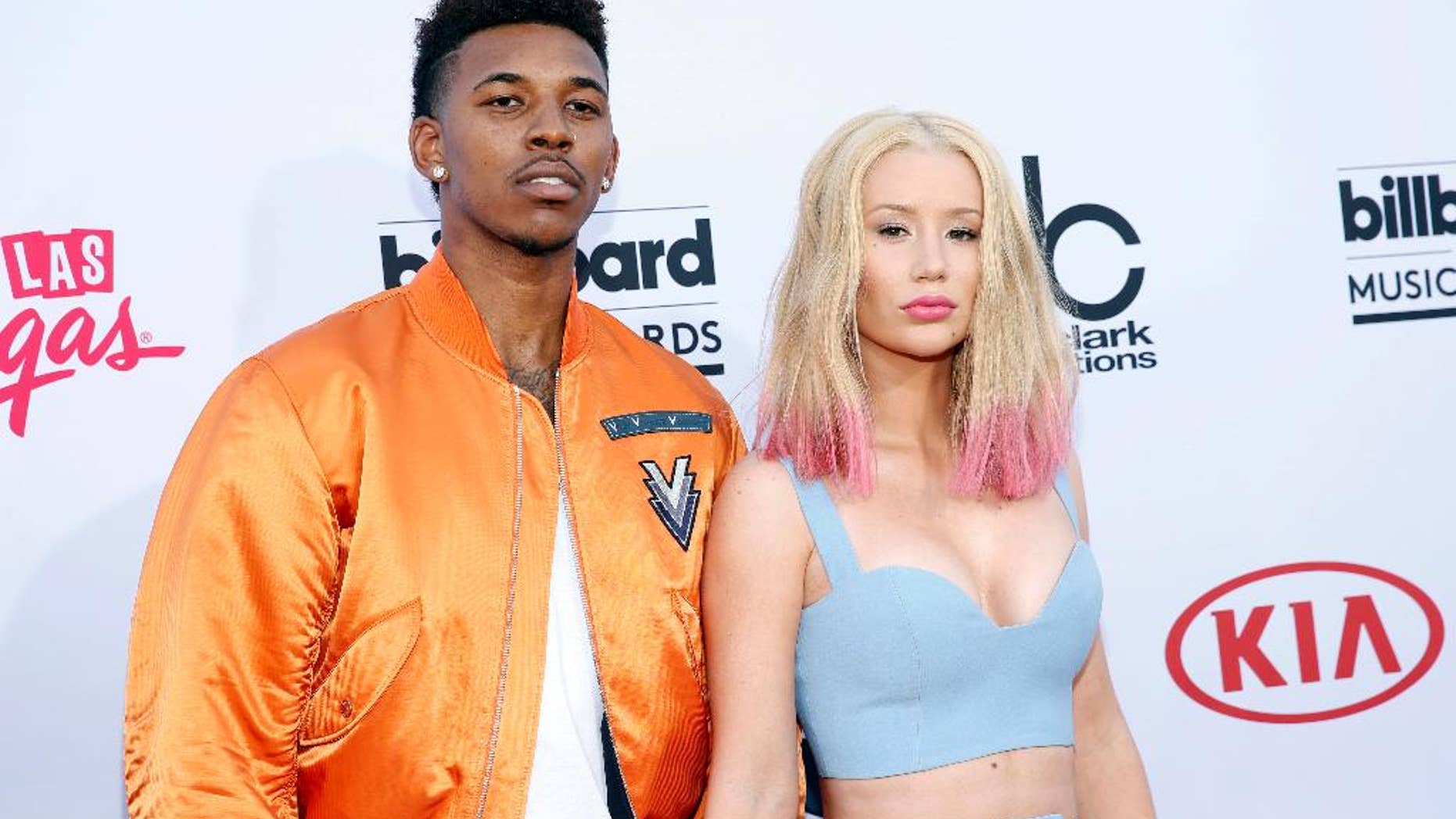 FILE - In this May 17, 2015 file photo, Nick Young, left, and Iggy Azalea arrive at the Billboard Music Awards at the MGM Grand Garden Arena in Las Vegas. Young proposed to the rapper late Monday, June 1, as they celebrated Young's 30th birthday. Azalea announced the couple's break up on social media Sunday, June 19, 2016. (Photo by Eric Jamison/Invision/AP, File)