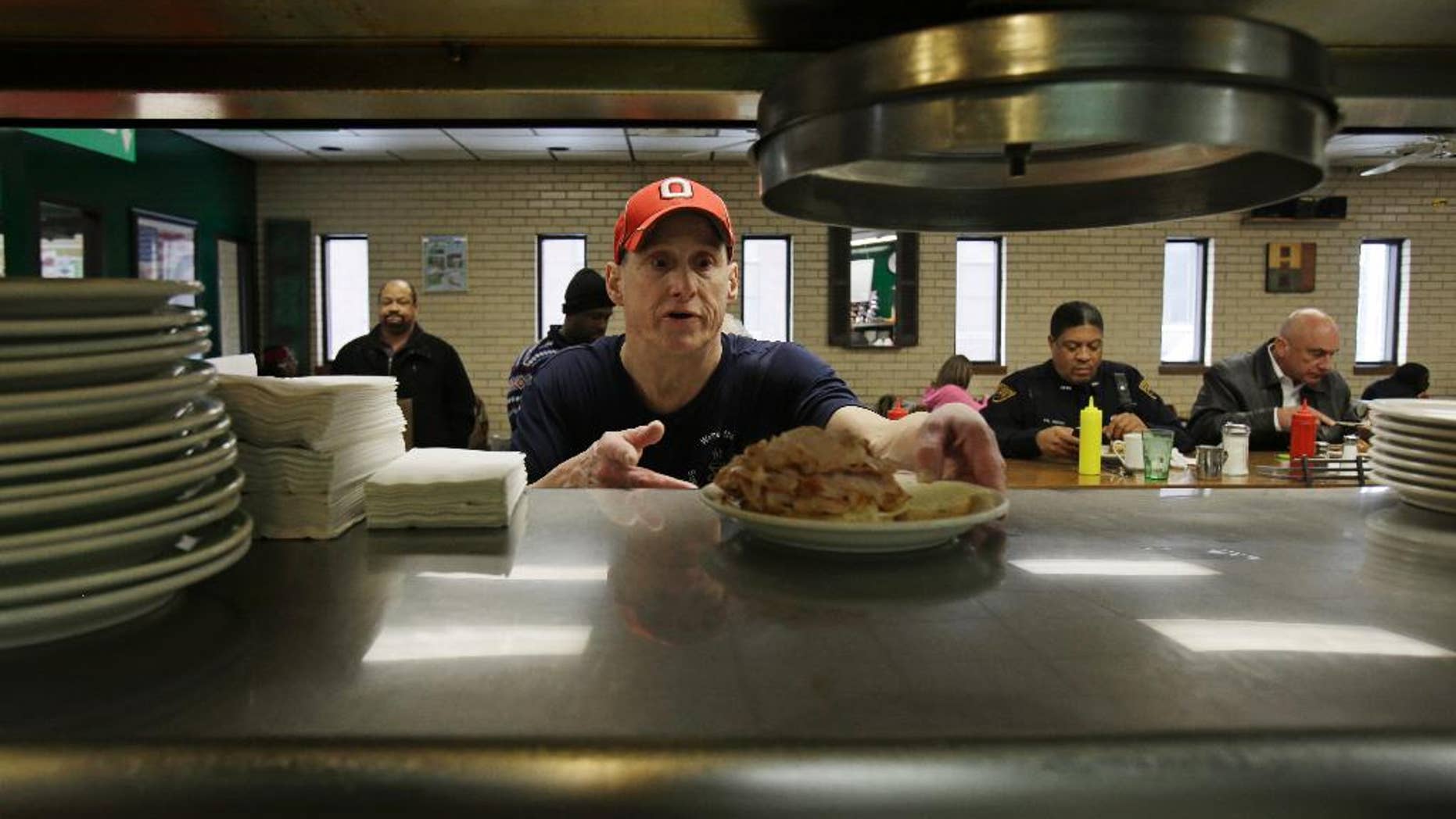 In this Jan. 23, 2015 photo, Mark Childers grabs a turkey reuben sandwich to deliver to a customer at the Superior Restaurant Friday, in Cleveland. The Labor Department reports on state unemployment rates for January on Tuesday, March 17, 2015. (AP Photo/Tony Dejak)