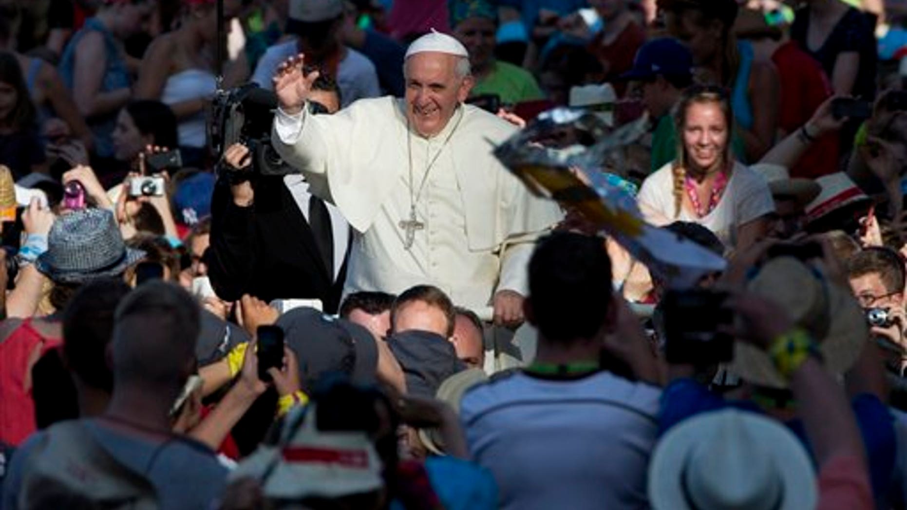 Pope Francis blesses faithful as he arrives in St. Peter's Square for a meeting with altar boys and girls from the dioceses of Germany, at the Vatican, Tuesday, Aug. 5, 2014. (AP Photo/Andrew Medichini)