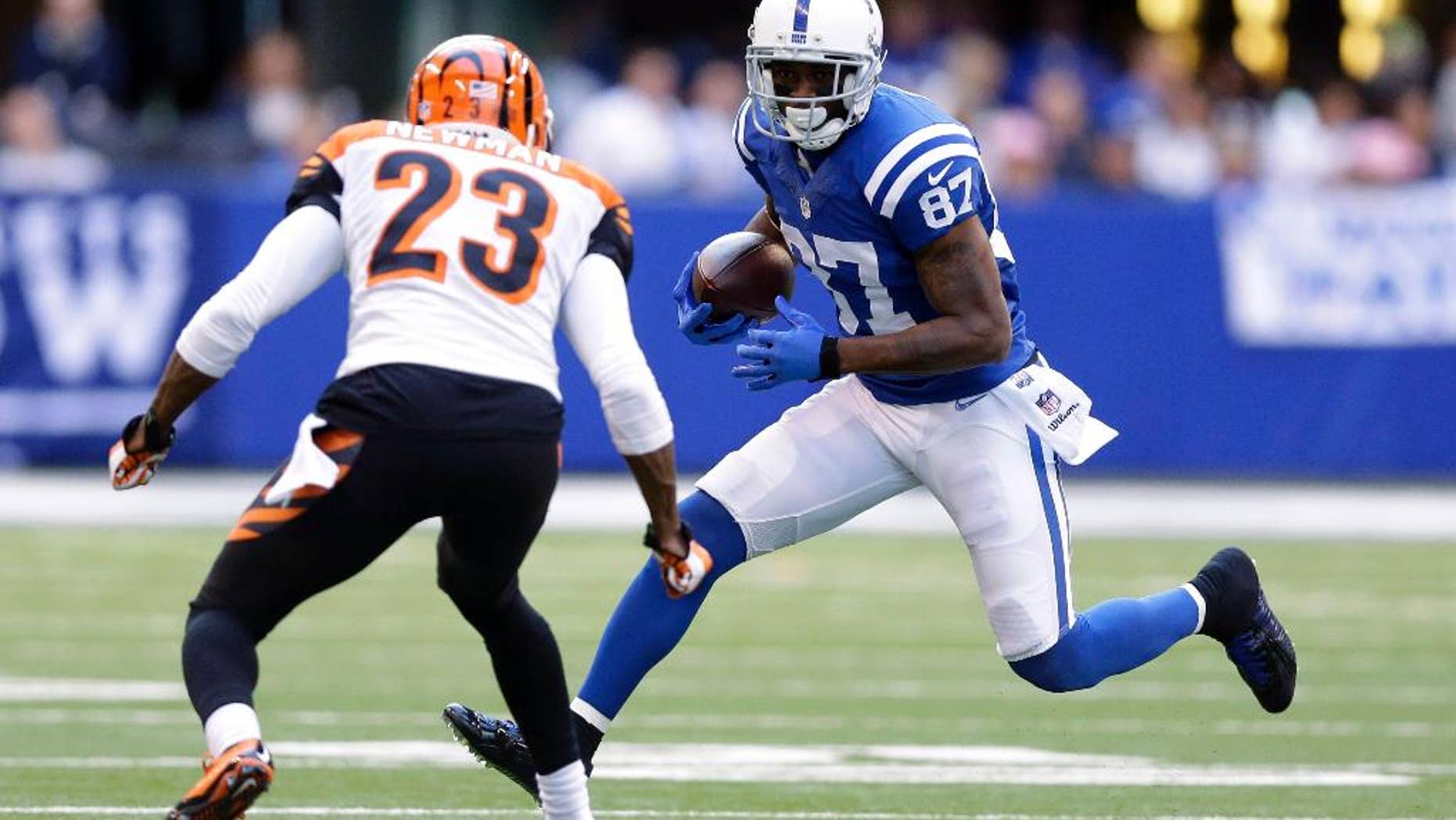 Indianapolis Colts wide receiver Reggie Wayne (87) runs against Cincinnati Bengals cornerback Terence Newman (23) during the second half of an NFL football game Sunday, Oct. 19, 2014, in Indianapolis. (AP Photo/Michael Conroy)