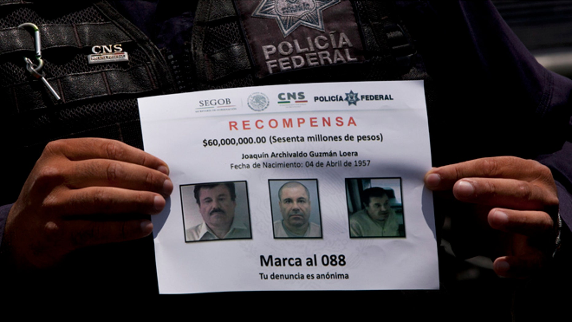 In this July 16, 2015, photo, a Federal Police shows a reward notice for information leading to the capture of drug lord Joaquin "El Chapo" Guzman, who made his escape from the Altiplano maximum security prison via an underground tunnel, in Almoloya, west of Mexico City. The Drug Enforcement Administrations deputy administrator says he is confident one of the worlds most-wanted drug traffickers will be captured again after a brazen weekend escape from a maximum-security Mexican prison. (AP Photo/Marco Ugarte)