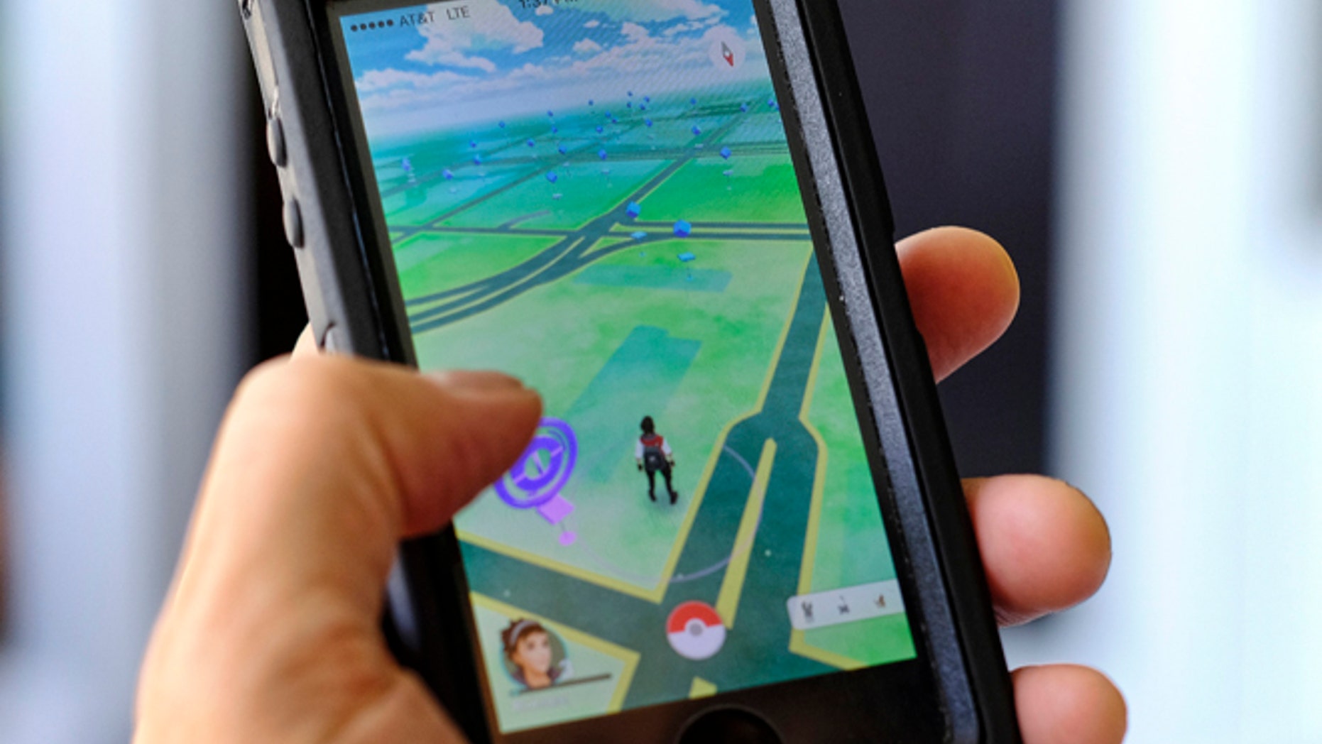 Pokemon Go is displayed on a cell phone in Los Angeles on Friday, July 8, 2016. Just days after being made available in the U.S., the mobile game Pokemon Go has jumped to become the top-grossing app in the App Store. And players have reported wiping out in a variety of ways as they wander the real world, eyes glued to their smartphone screens, in search of digital monsters. (AP Photo/Richard Vogel)