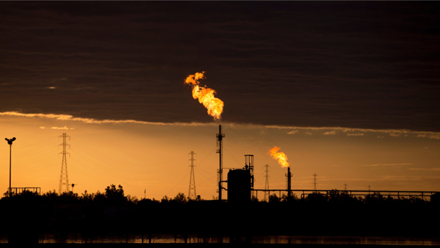 In this Feb. 18, 2015 photo, flames burn at an oil complex near El Tigre, a town located within Venezuela's Hugo Chavez oil belt, formally known as the Orinoco Belt. The Costa Rica-sized area is home to the worlds largest oil reserves and about half of Venezuelas current production. (AP Photo/Fernando Llano)