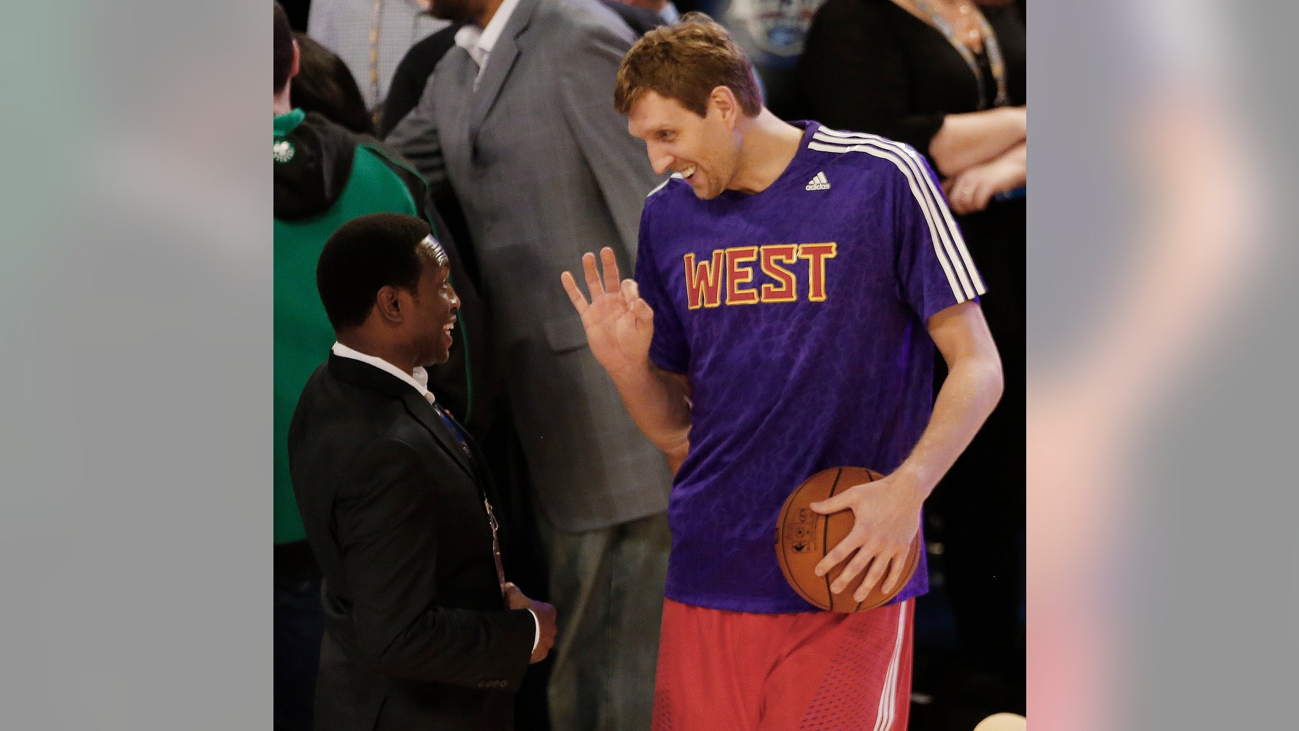 Former NBA player Avery Johnson, left speaks with West Team's Dirk Nowitzki, of the Dallas Mavericks (41) before the NBA All Star basketball game, Sunday, Feb. 16, 2014, in New Orleans. (AP Photo/Bill Haber)