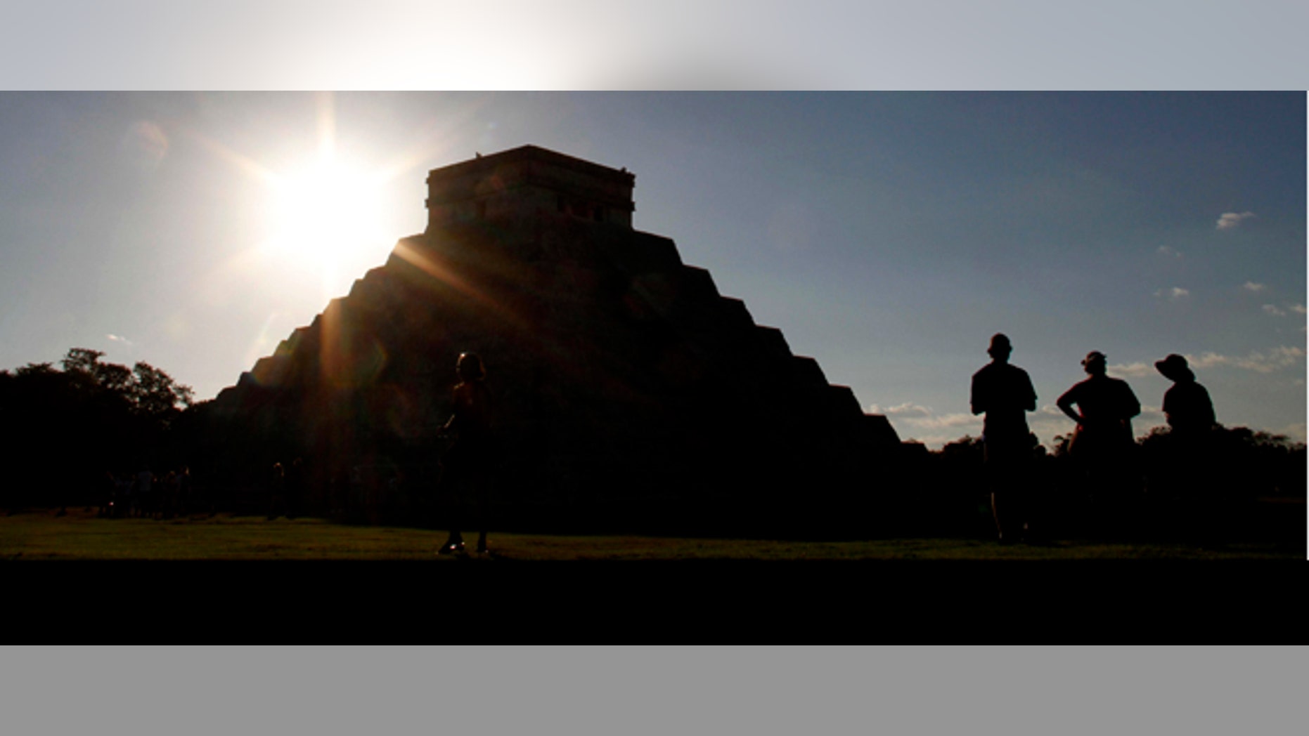 People gather in front of the Kukulkan Pyramid in Chichen Itza, Mexico, Thursday, Dec. 20, 2012. American seer Star Johnsen-Moser led a whooping, dancing, drum-beating ceremony Thursday in the heart of Mayan territory to consult several of the life-sized crystal skulls, which adherents claim were passed down by the ancient Maya. (AP Photo/Israel Leal)