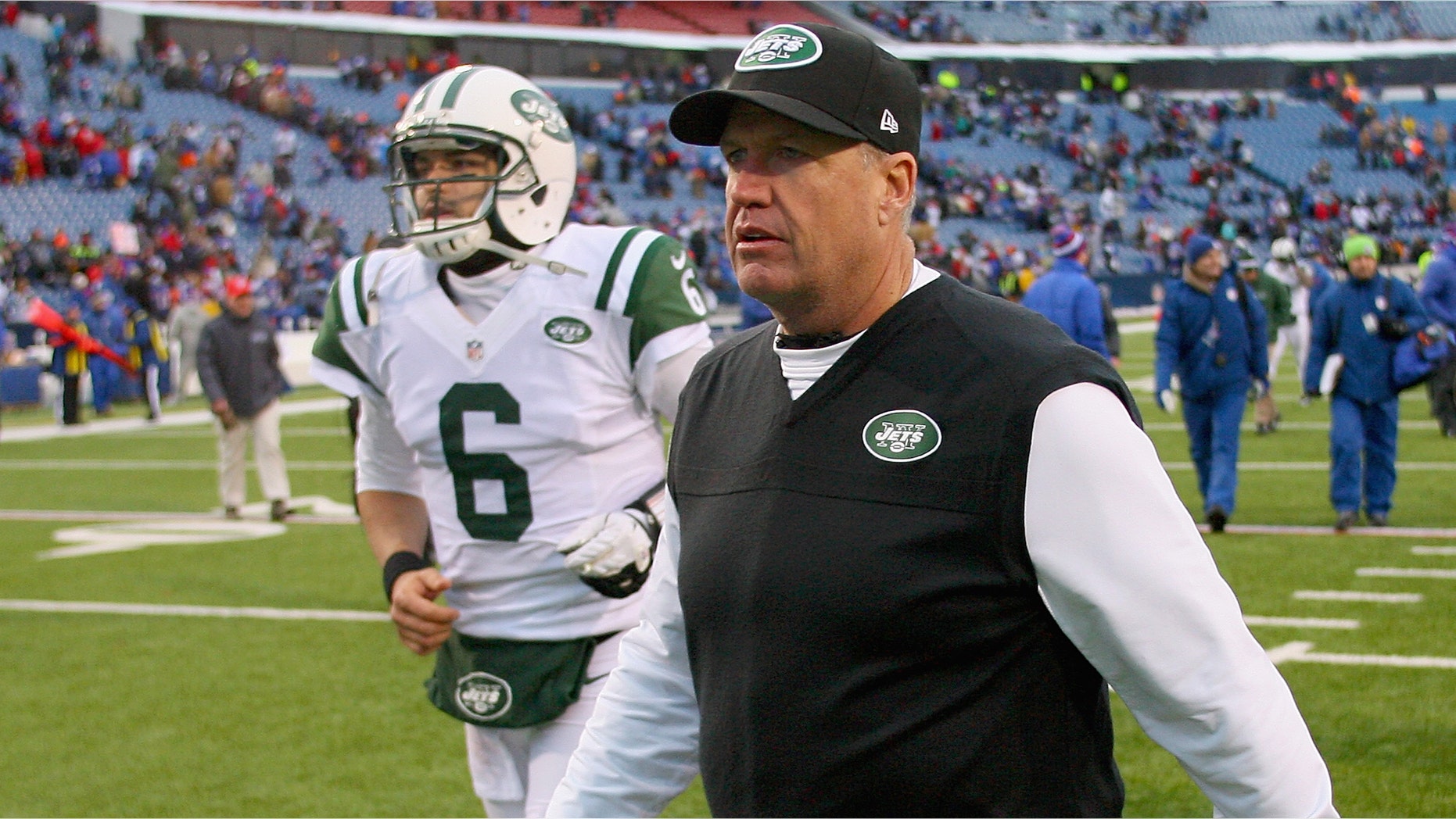 Head coach Rex Ryan and Mark Sanchez #6 of the New York Jets walk off the field after losing to the Buffalo Bills 28-9 at Ralph Wilson Stadium on December 30, 2012 in Orchard Park, New York.