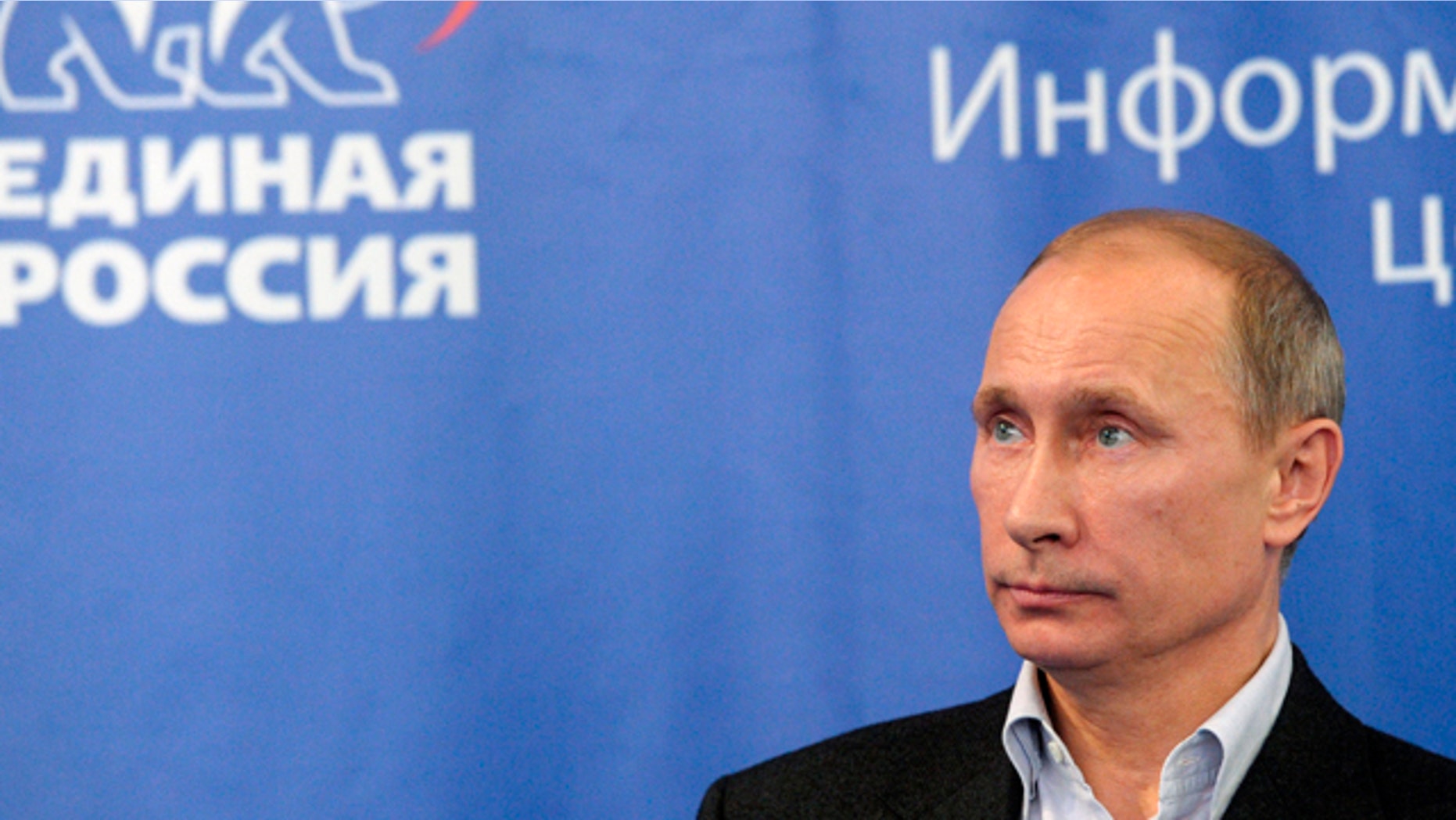 Dec. 4, 2011: Prime Minister Vladimir Putin, with the emblem of the United Russia party in the background, visits the United Russia party headquarters in Moscow.