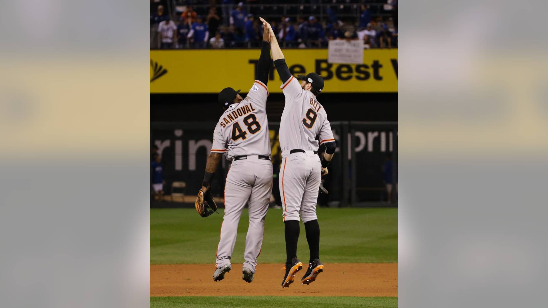 San Francisco Giants third baseman Pablo Sandoval (48) and teammate Brandon Belt celebrate following their 7-1 victory over the Kansas City Royals in Game 1 of baseball's World Series Tuesday, Oct. 21, 2014, in Kansas City, Mo. (AP Photo/Matt Slocum )