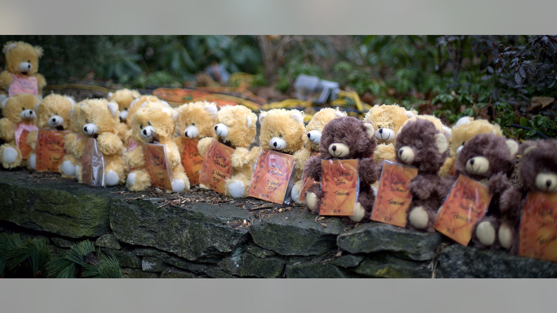 Teddy bears, each representing a victim of the Sandy Hook Elementary School shooting, sit on a wall at a sidewalk memorial Dec. 16, 2012, in Newtown, Conn. A gunman walked into Sandy Hook Elementary School in Newtown Friday and opened fire, killing 26 people, including 20 children.
